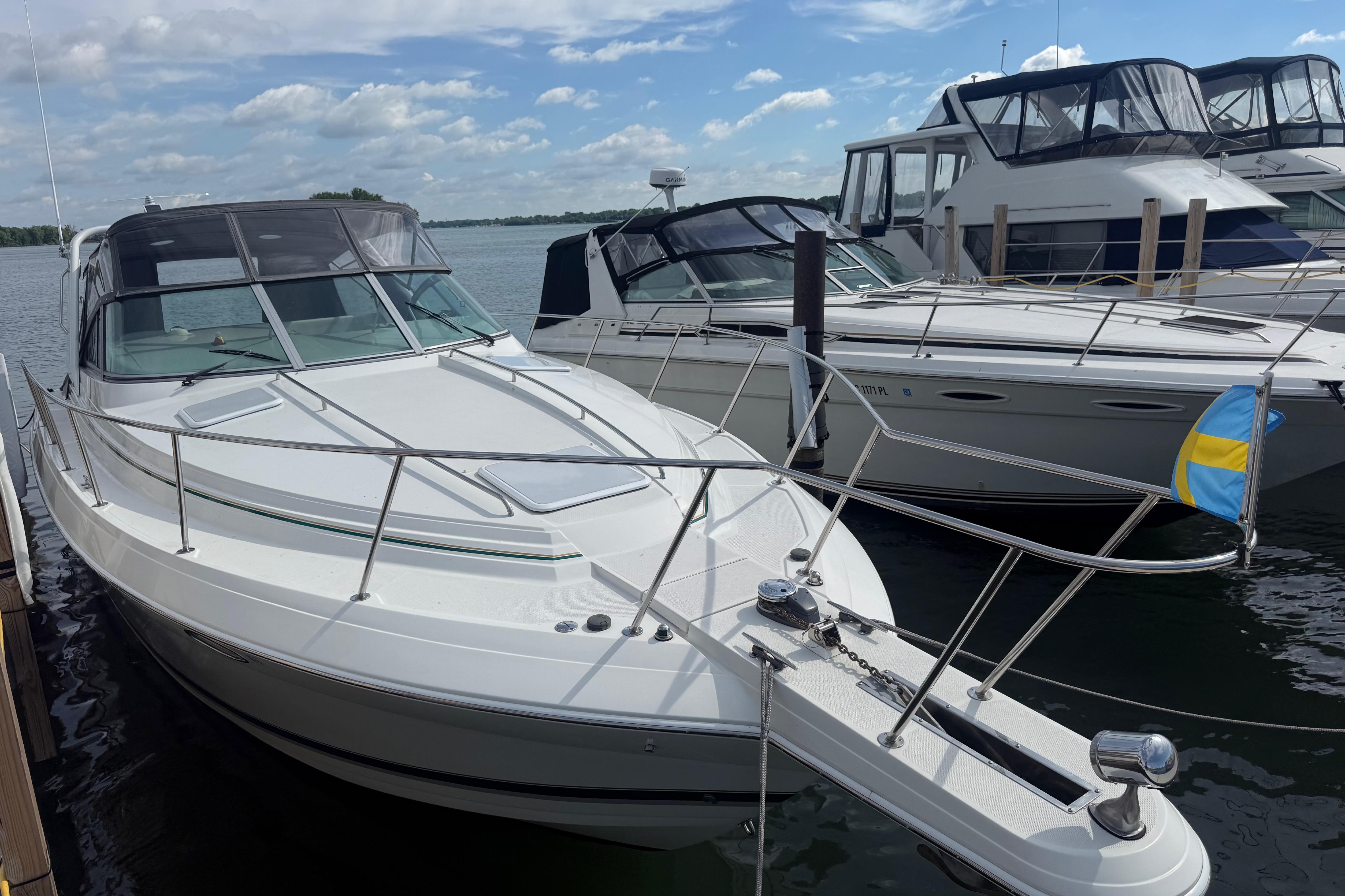 1999 Formula 34 Performance Cruiser docked, featuring sleek design and spacious deck under a clear sky.