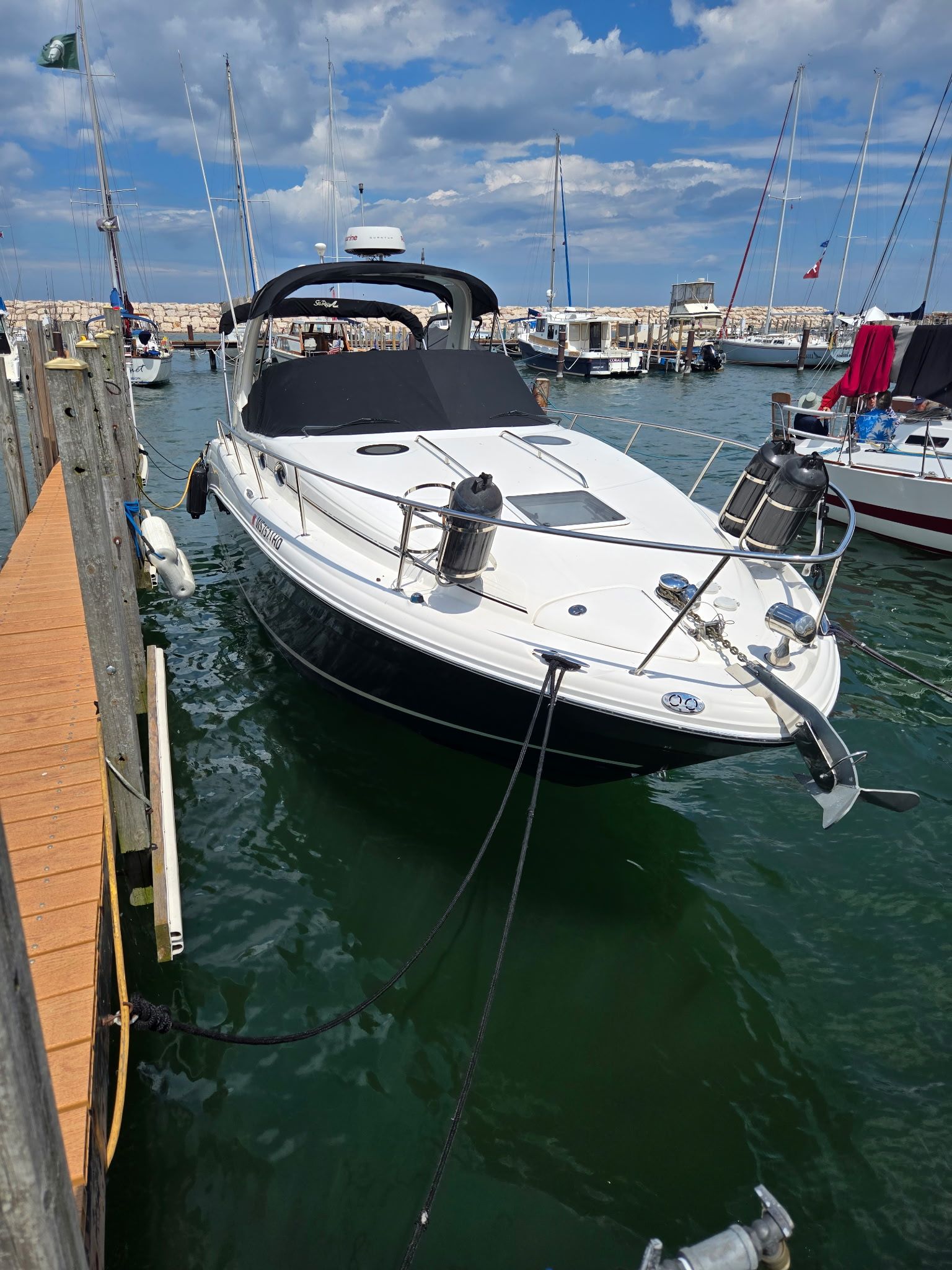 A 2006 Sea Ray 300 Sundancer docked at a harbor.