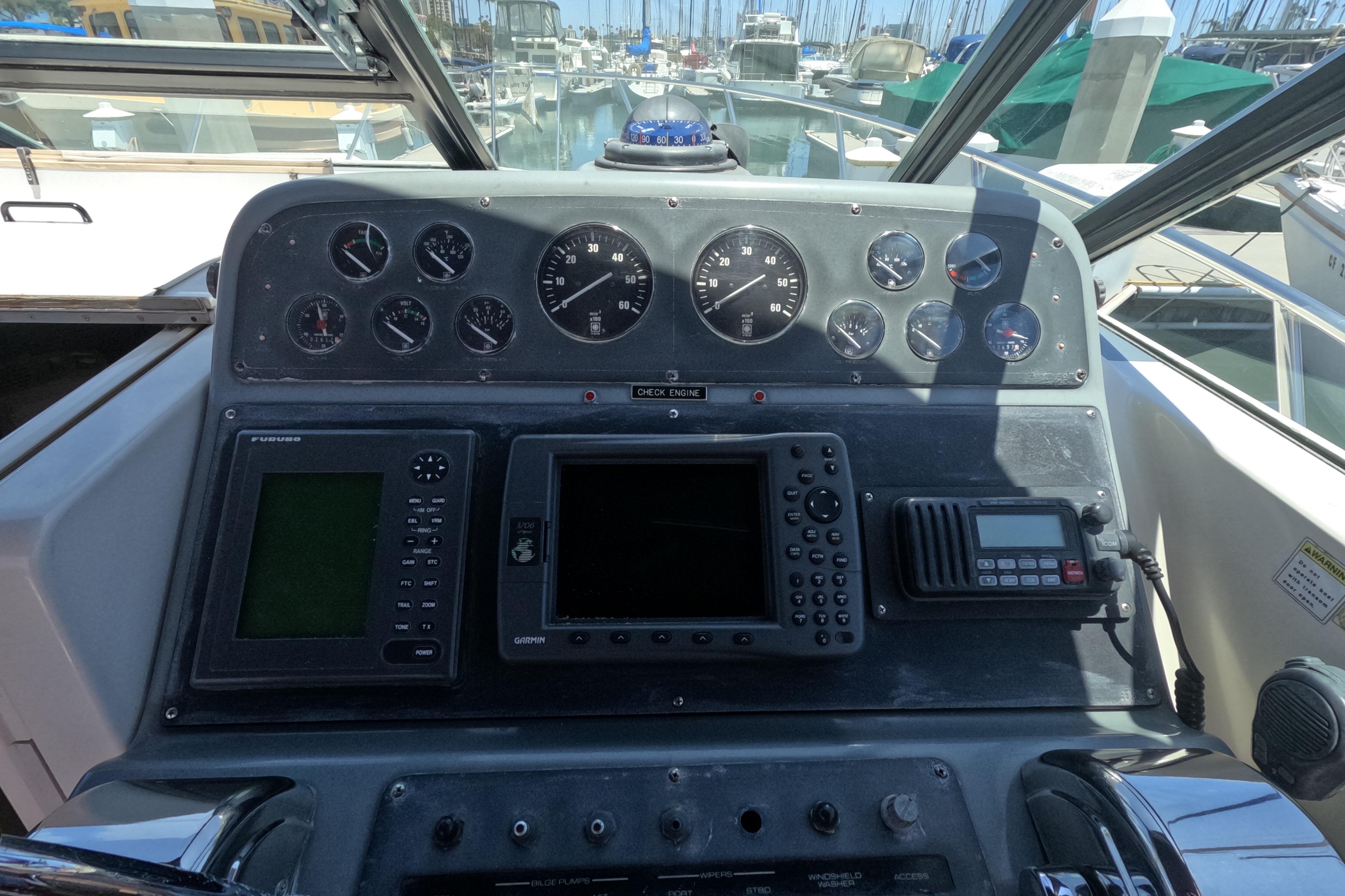 1995 Tiara Yachts 2900 Open dashboard with gauges, navigation, and communication equipment.