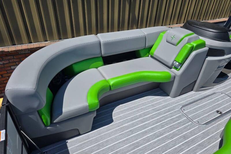 2026 Berkshire STS Arch Performance Series boat with gray and green seating.