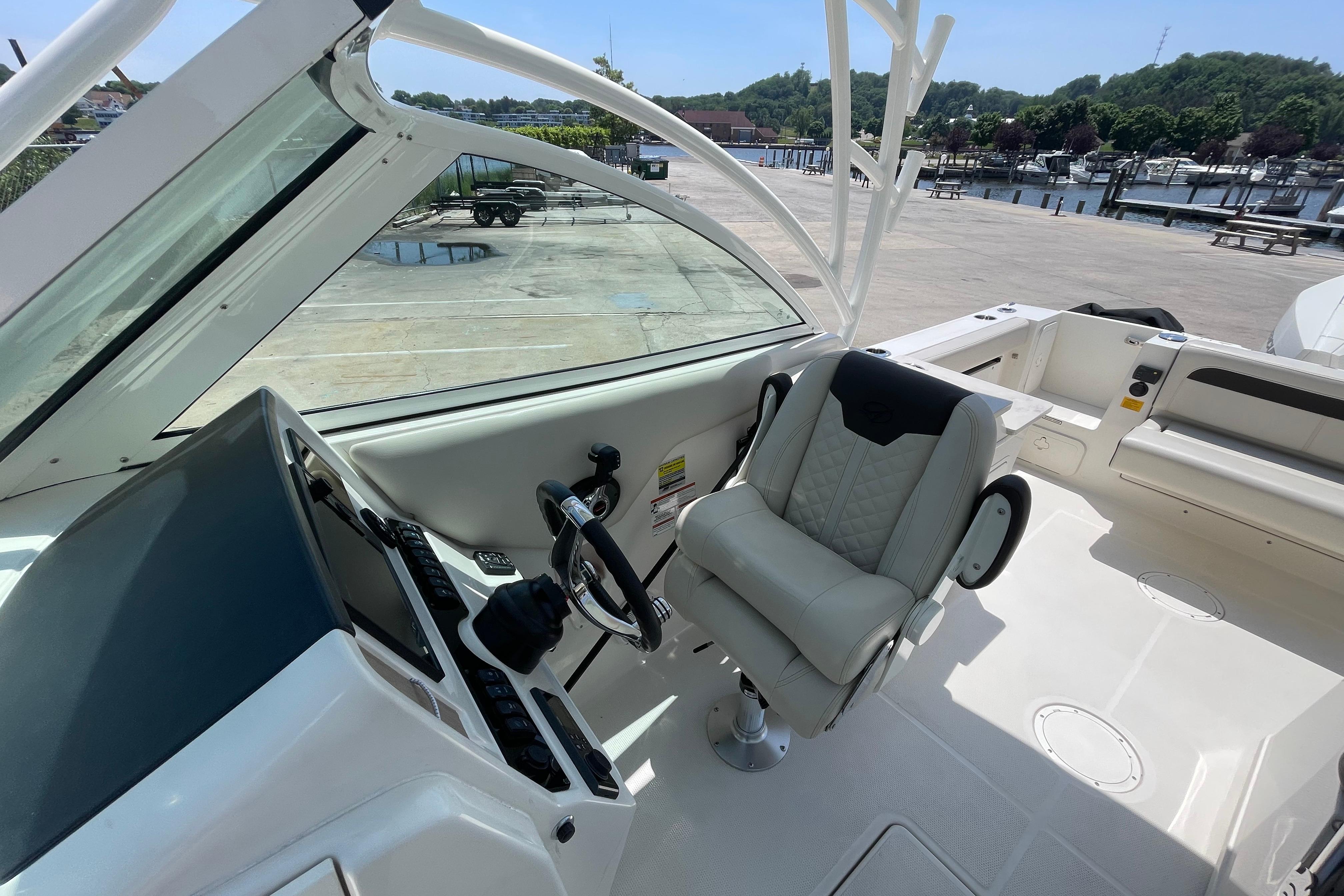 2022 Sailfish 245 DC boat interior with helm, steering wheel, and captain's chair.