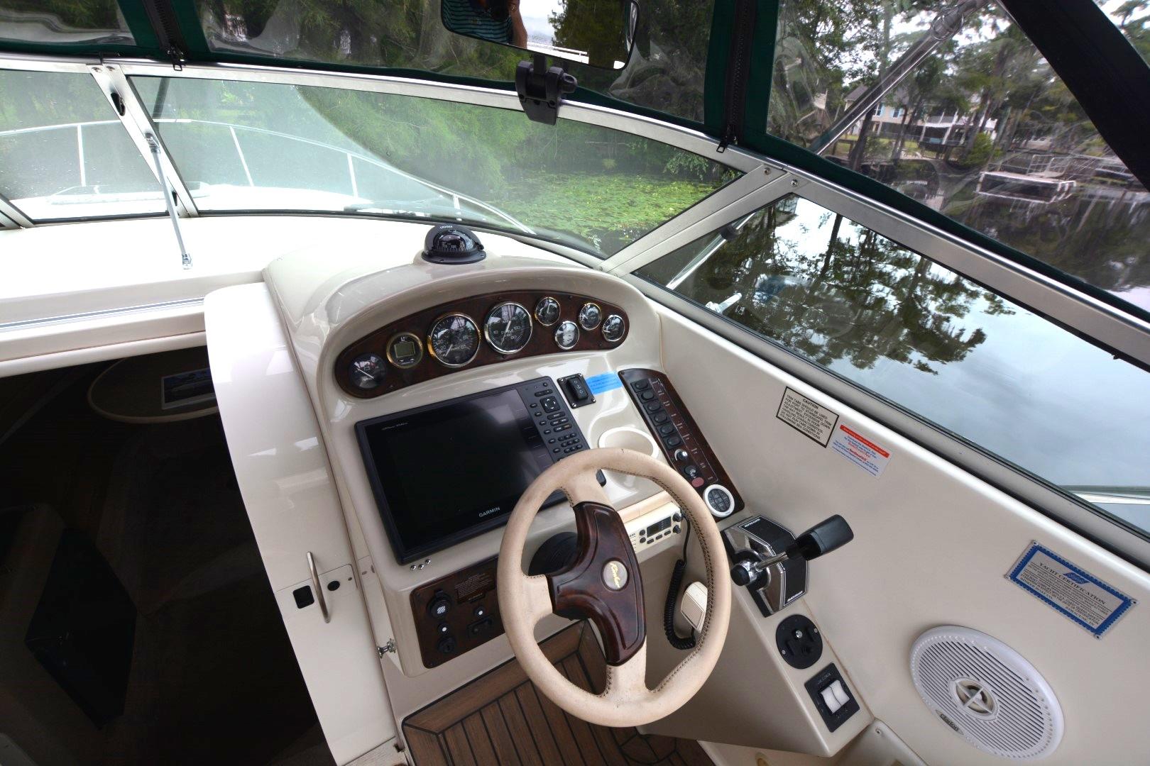 1999 Rinker 270 Fiesta Vee boat helm with steering wheel and control panel.