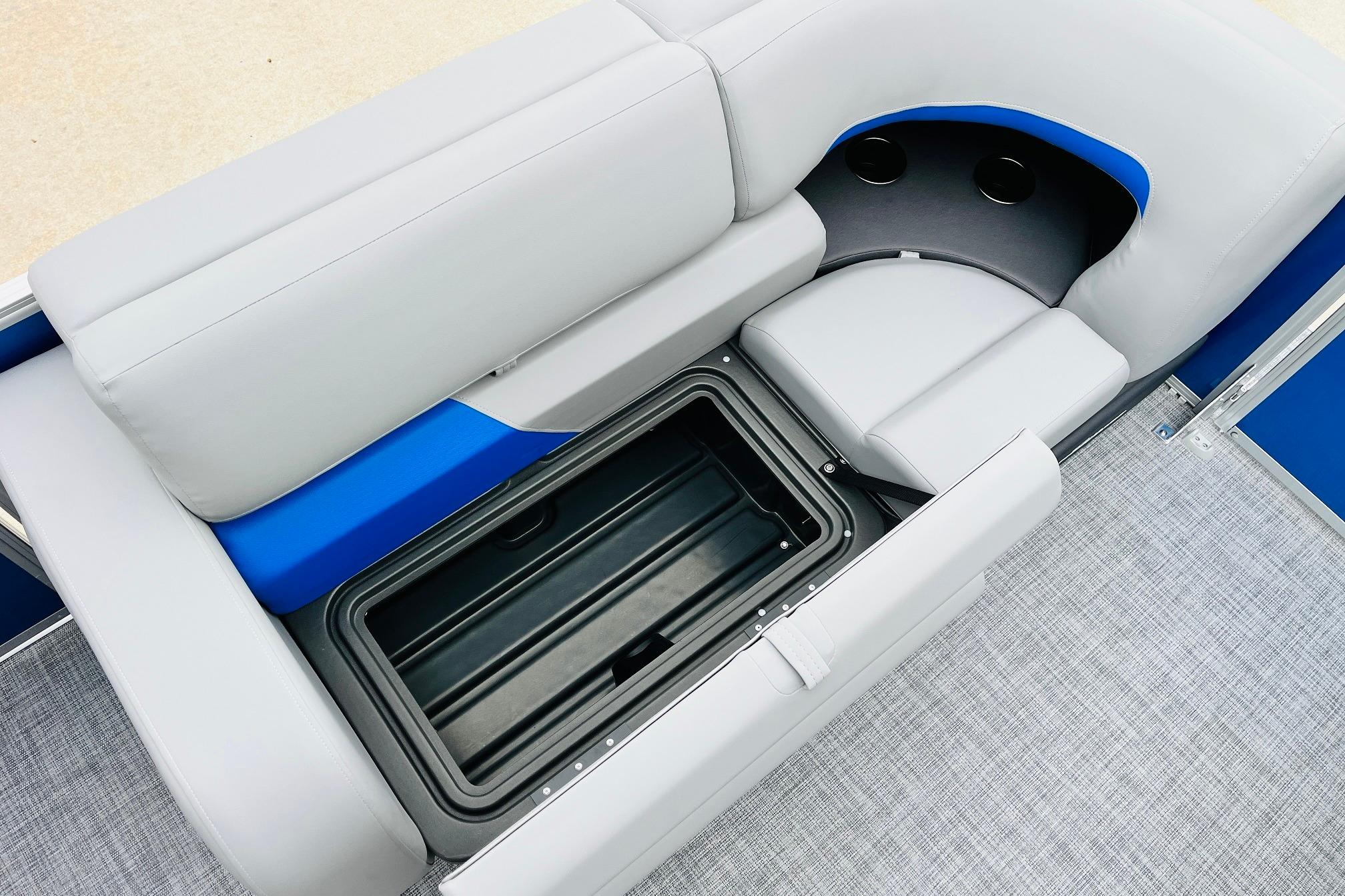 Sun Tracker Party Barge 22 RF DLX 2026 interior with storage compartment and cup holders.