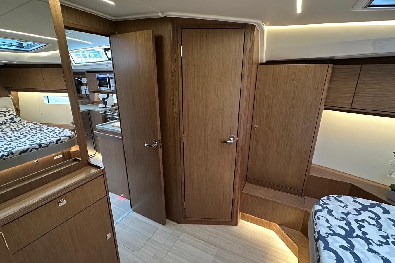 Luxurious interior of 2025 Bavaria C46 yacht with modern wood finish and cozy sleeping area.