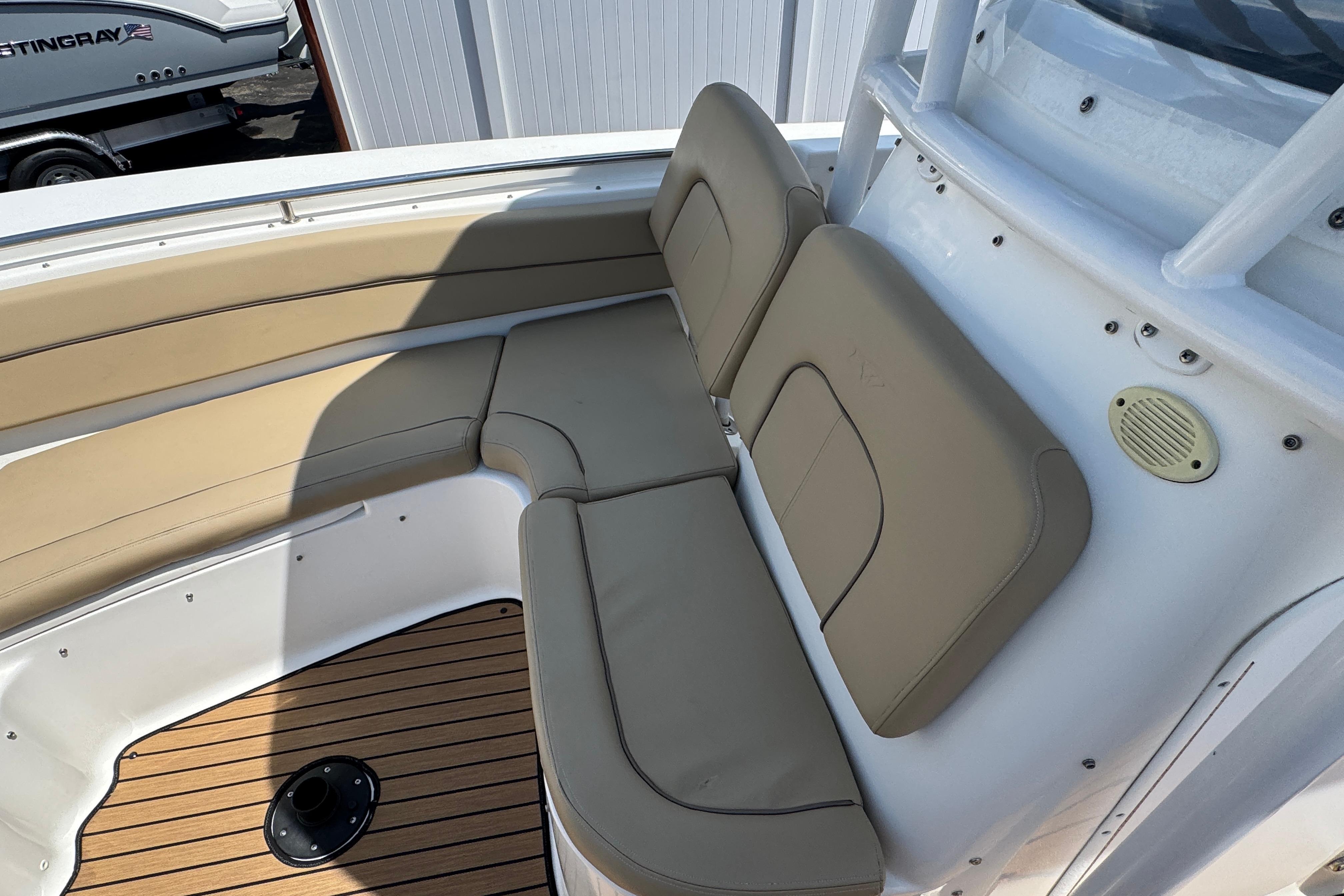 2016 Tidewater 230 LXF boat interior with beige seating and wood flooring.