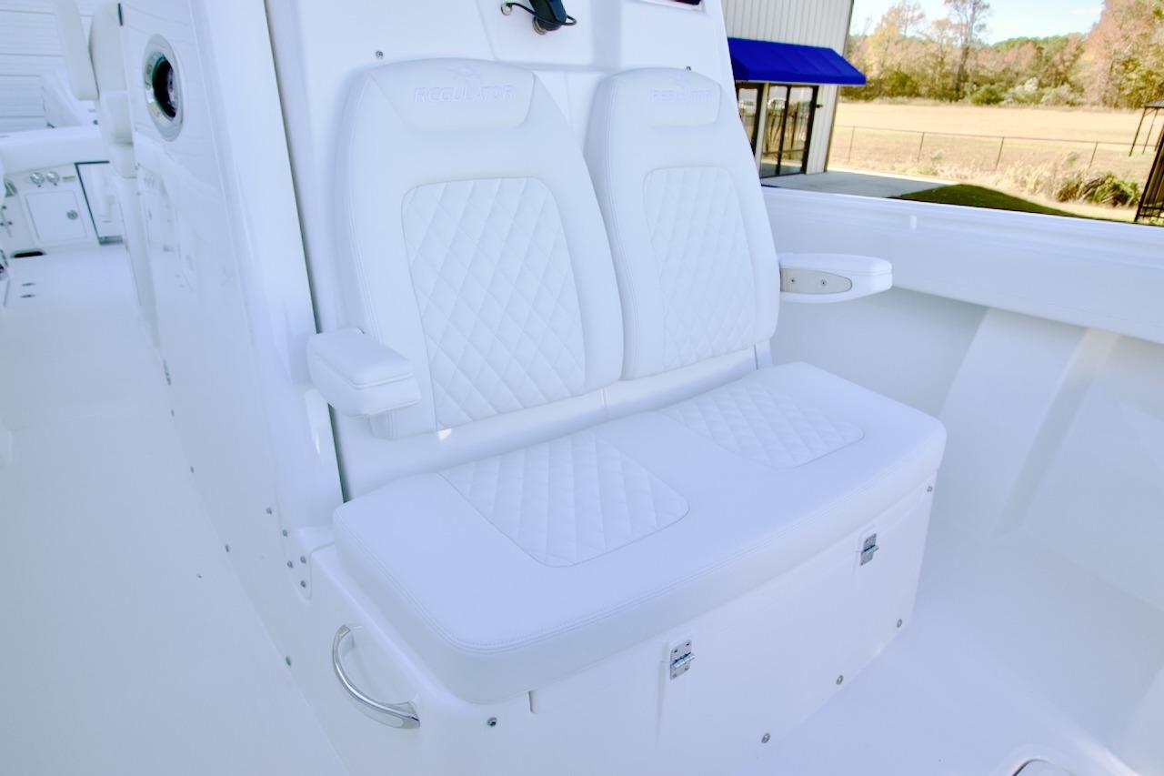 Luxurious white seating on 2026 Regulator 31 boat, featuring diamond-stitched upholstery.