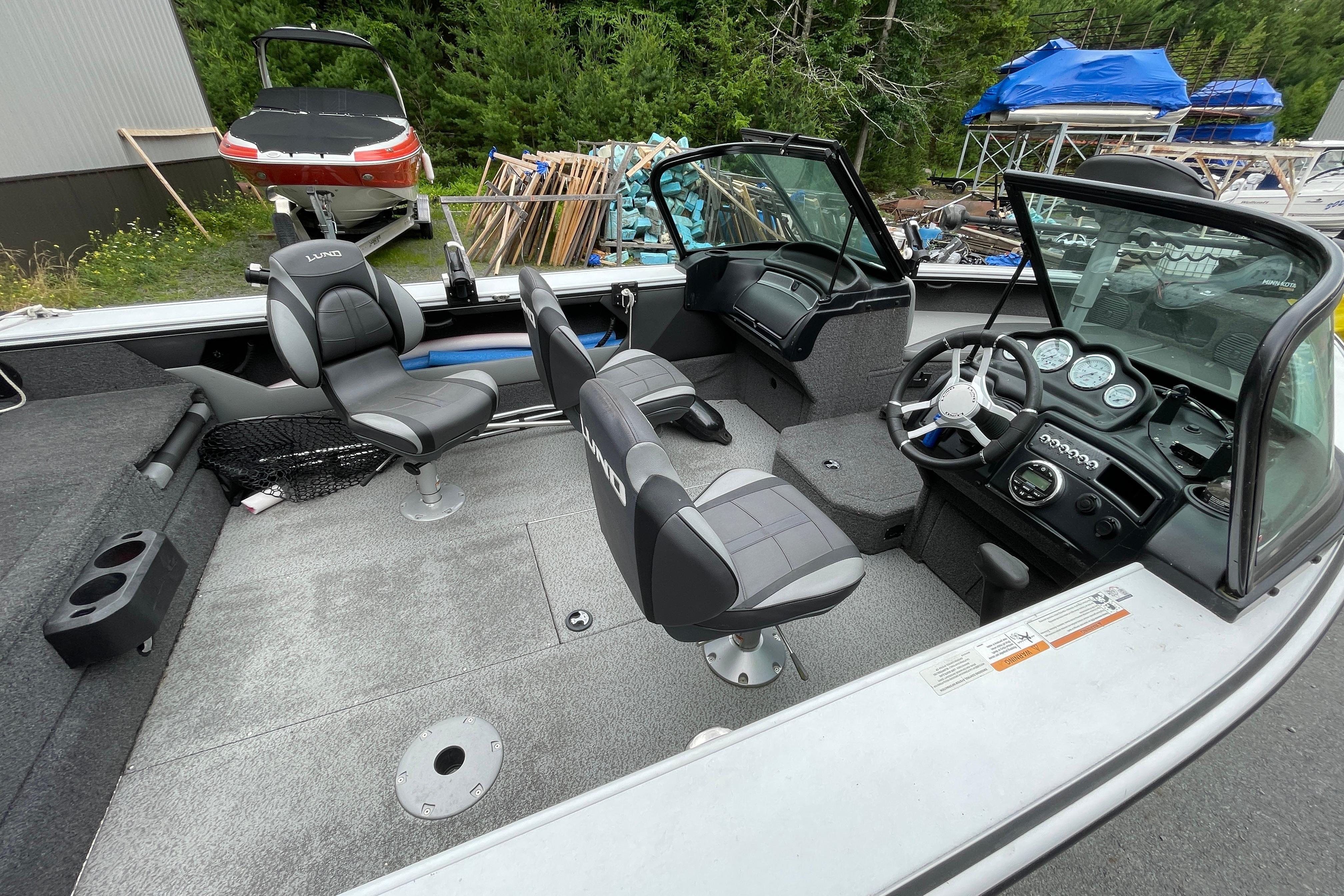 2022 Lund 1875 Crossover XS boat interior with seating and control panel.