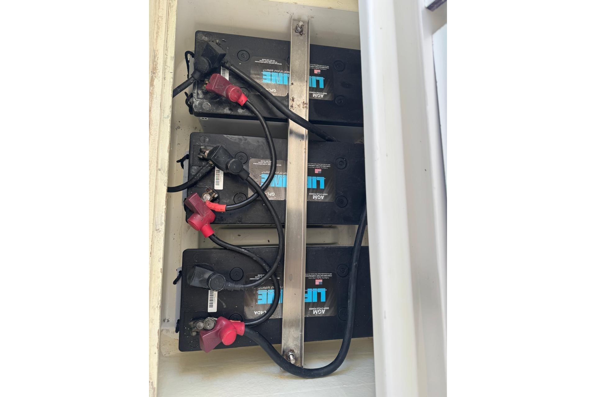 Battery compartment of a 2017 Leopard 45 yacht, featuring multiple connected batteries.