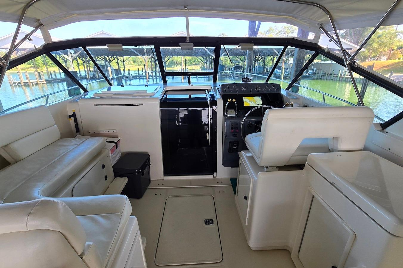 1996 Tiara Yachts 3700 Open interior with helm, seating, and water view.