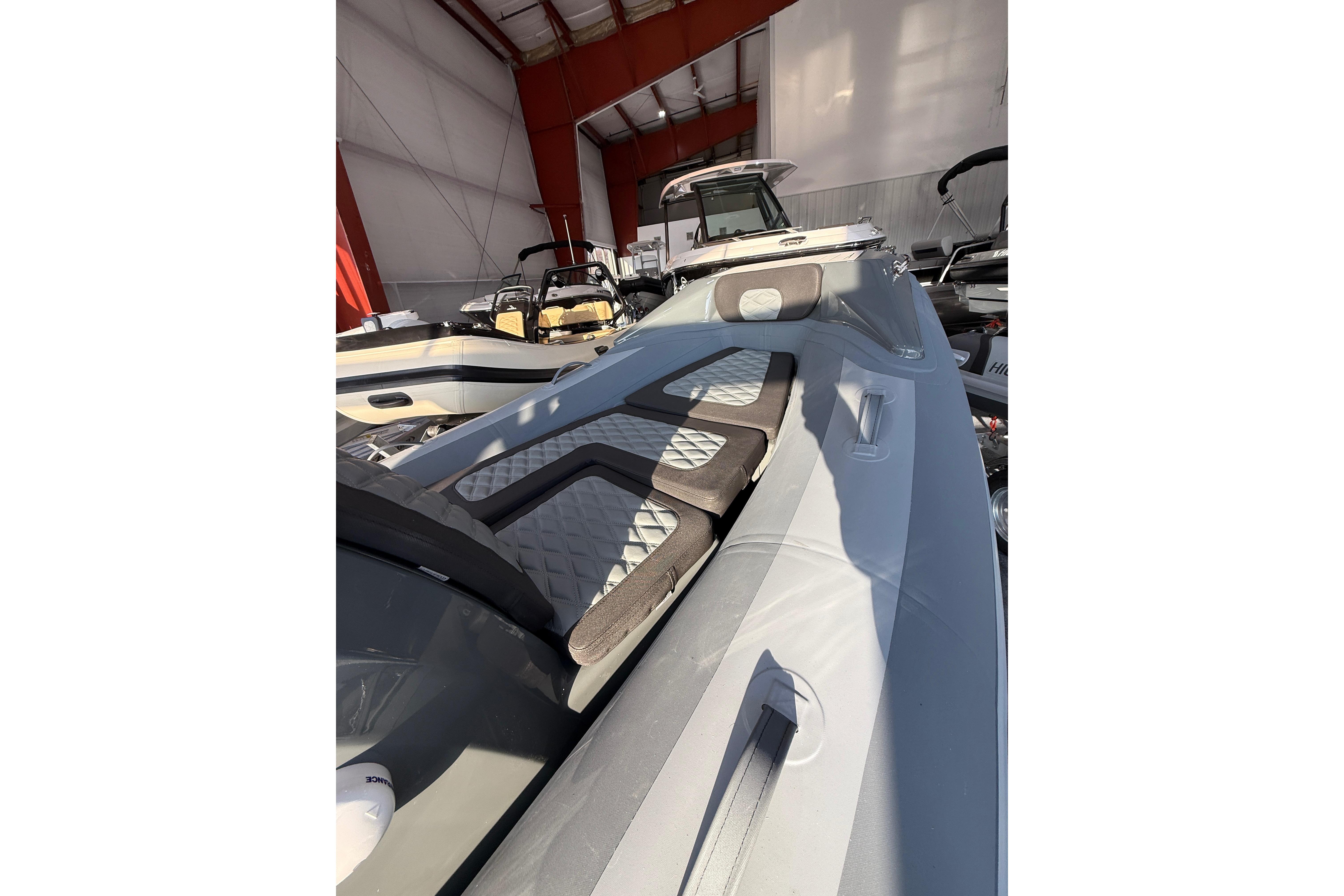 2026 Highfield Sport 390 boat interior in a showroom, featuring sleek design and seating.