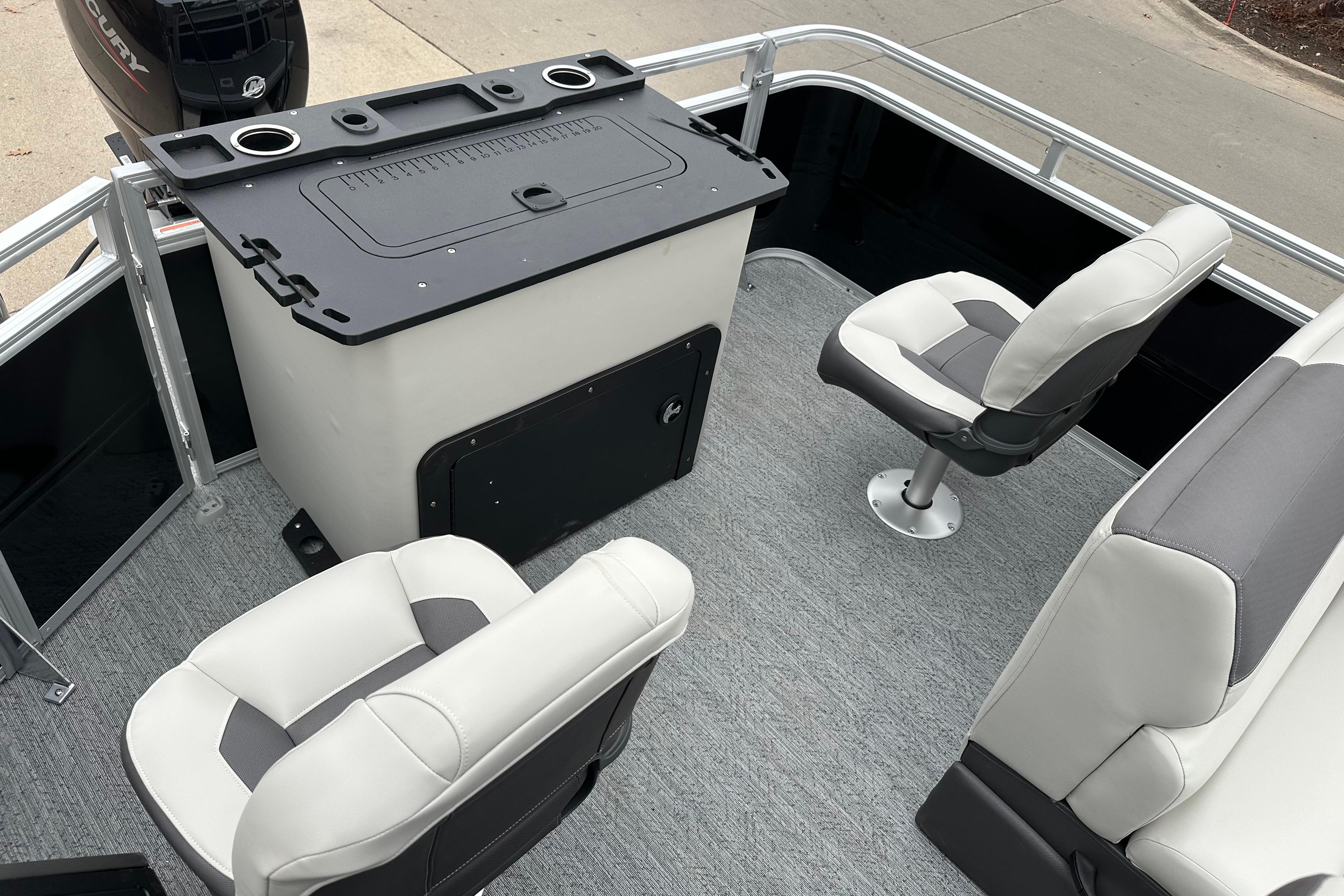 2026 Sun Tracker Fishin' Barge 22 DLX interior with seating and fishing station.