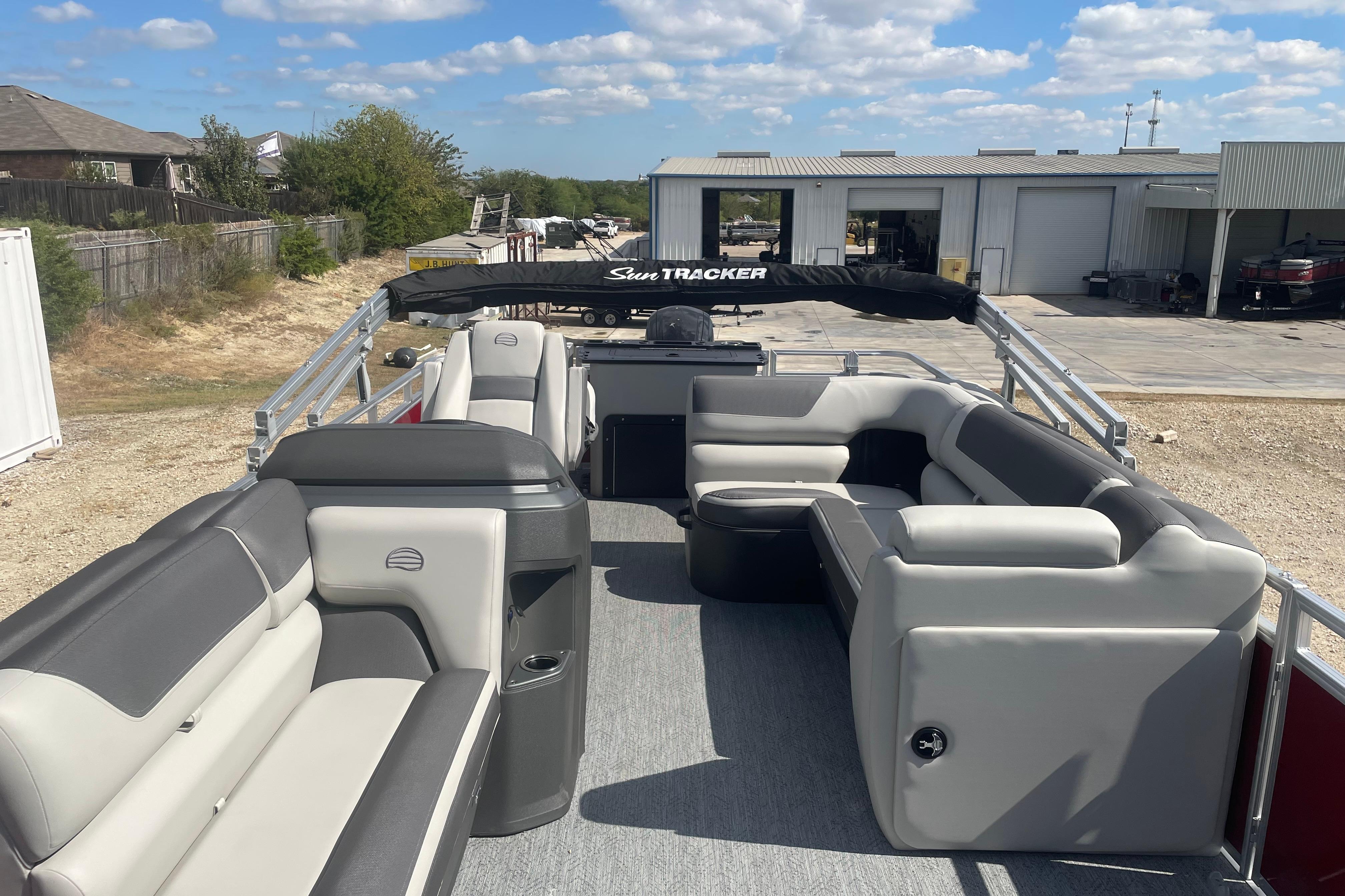 2026 Sun Tracker Fishin' Barge 22 DLX pontoon boat with spacious seating and modern design.