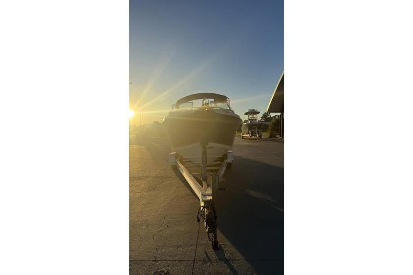 2006 Seaswirl Striper 2101 Dual Console OB on trailer at sunset.