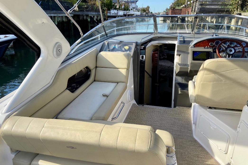 Interior of 2012 Regal 35 Express Cruiser with beige seating and modern dashboard.