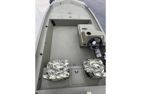 2026 Tracker Grizzly 1754 SC boat interior with camo seats and steering console.