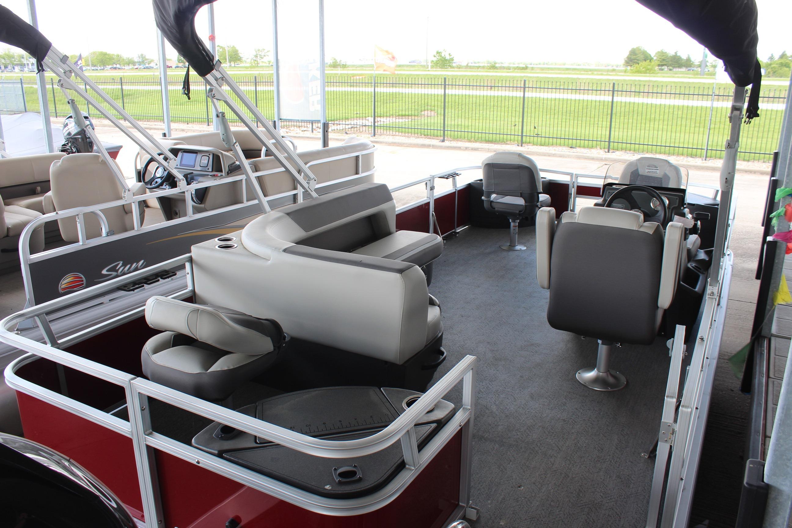 2026 Sun Tracker Bass Buggy 18 DLX pontoon boat interior with seating and steering console.