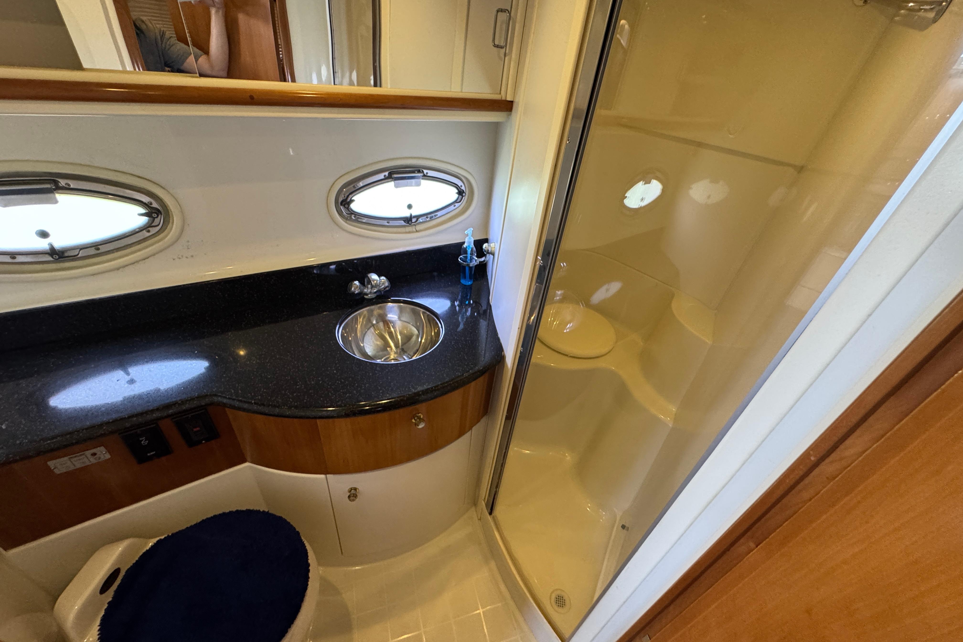 Luxurious bathroom in 2002 Carver 396 Motor Yacht with sleek sink and shower.