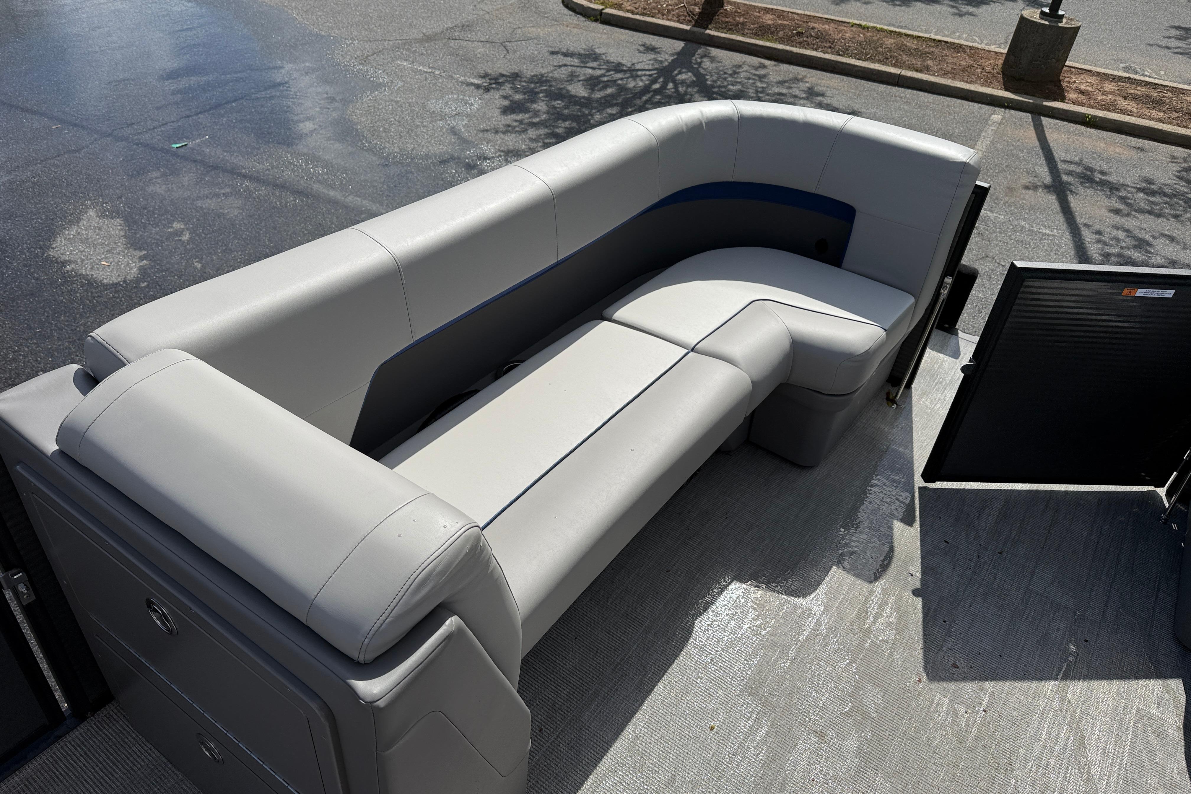 Interior of Qwest SplashPad 22 TriToon 2025 with gray seating.