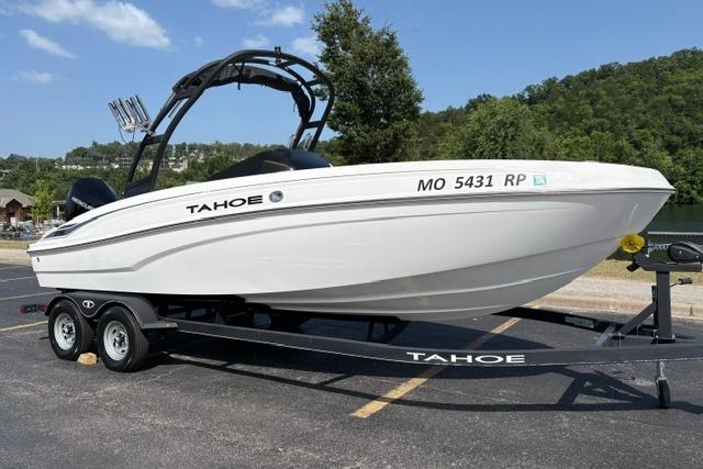 2024 Tahoe T21 boat on trailer, parked outdoors with scenic background.