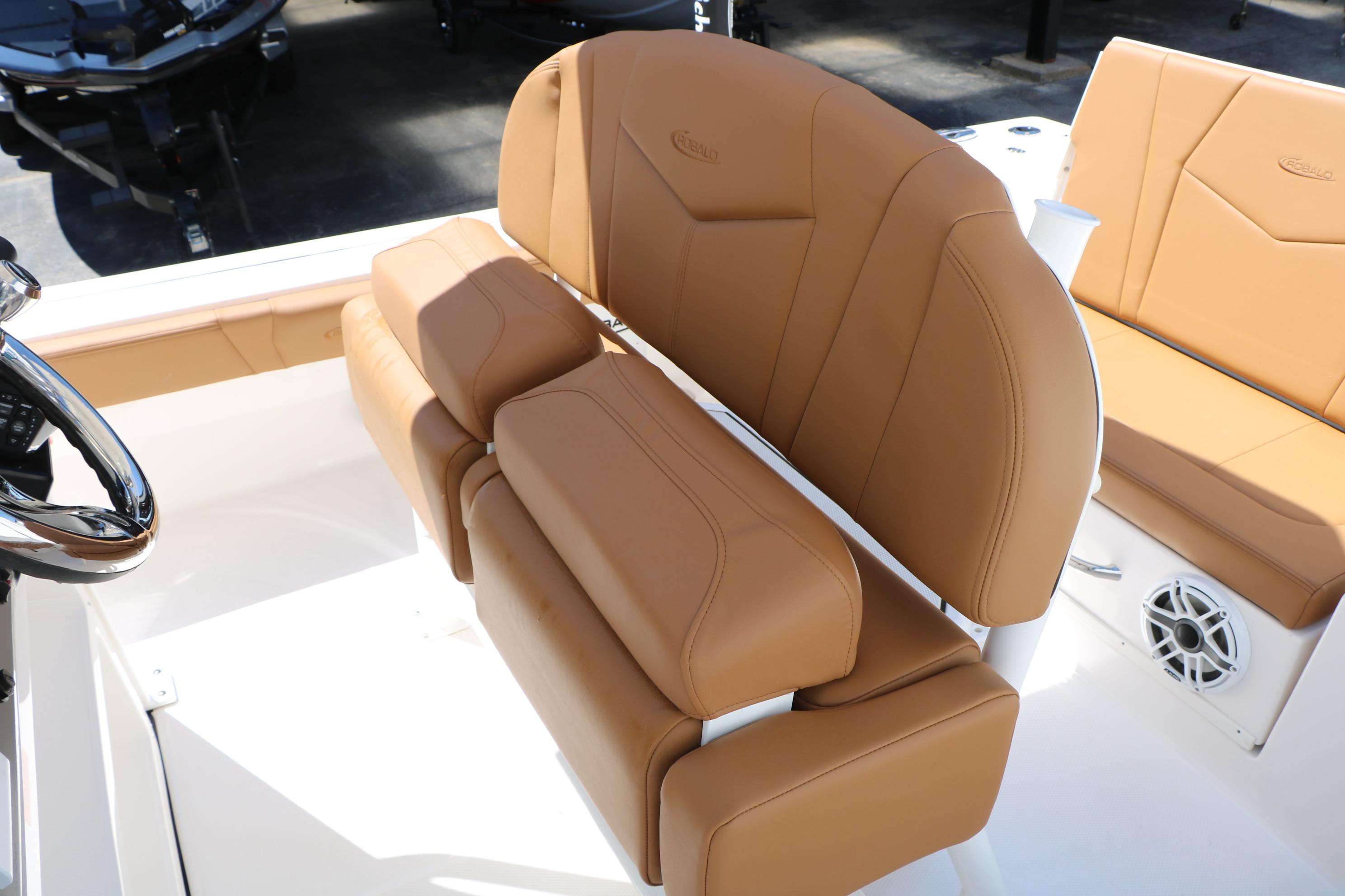 2026 Robalo 246 Cayman boat interior with tan leather seating and steering wheel.