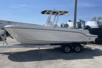 2023 Trophy T24 CC boat on trailer, parked outdoors under clear blue sky.