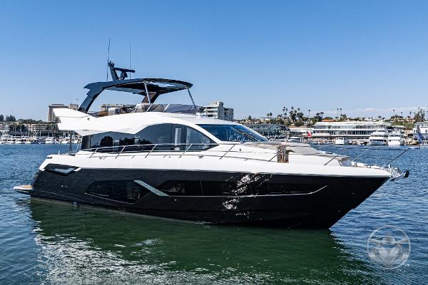 2025 Sunseeker Manhattan 68 yacht on calm water, sleek design, luxury vessel.