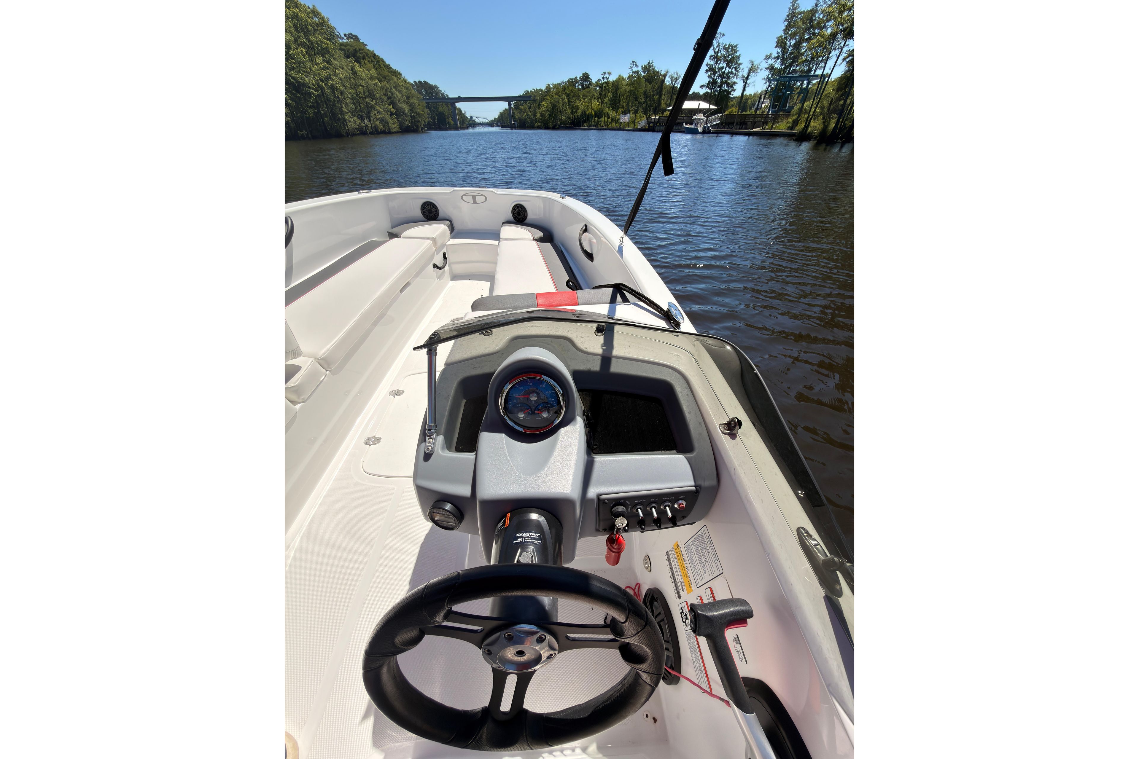 Interior view of a 2022 Tahoe T18 boat on a scenic river.