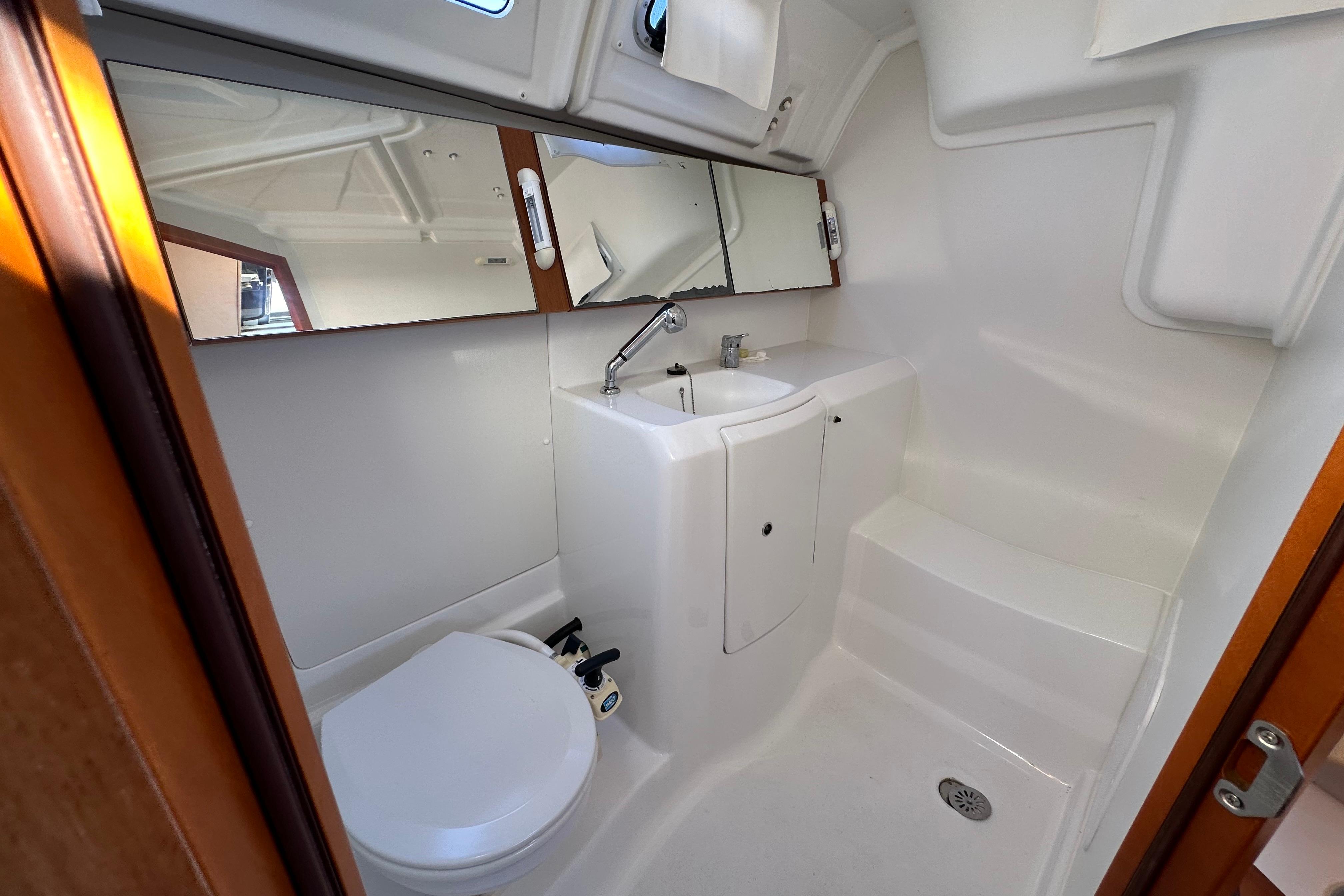Beneteau Oceanis 37 yacht bathroom, 2015 model, featuring sink, toilet, and mirror.