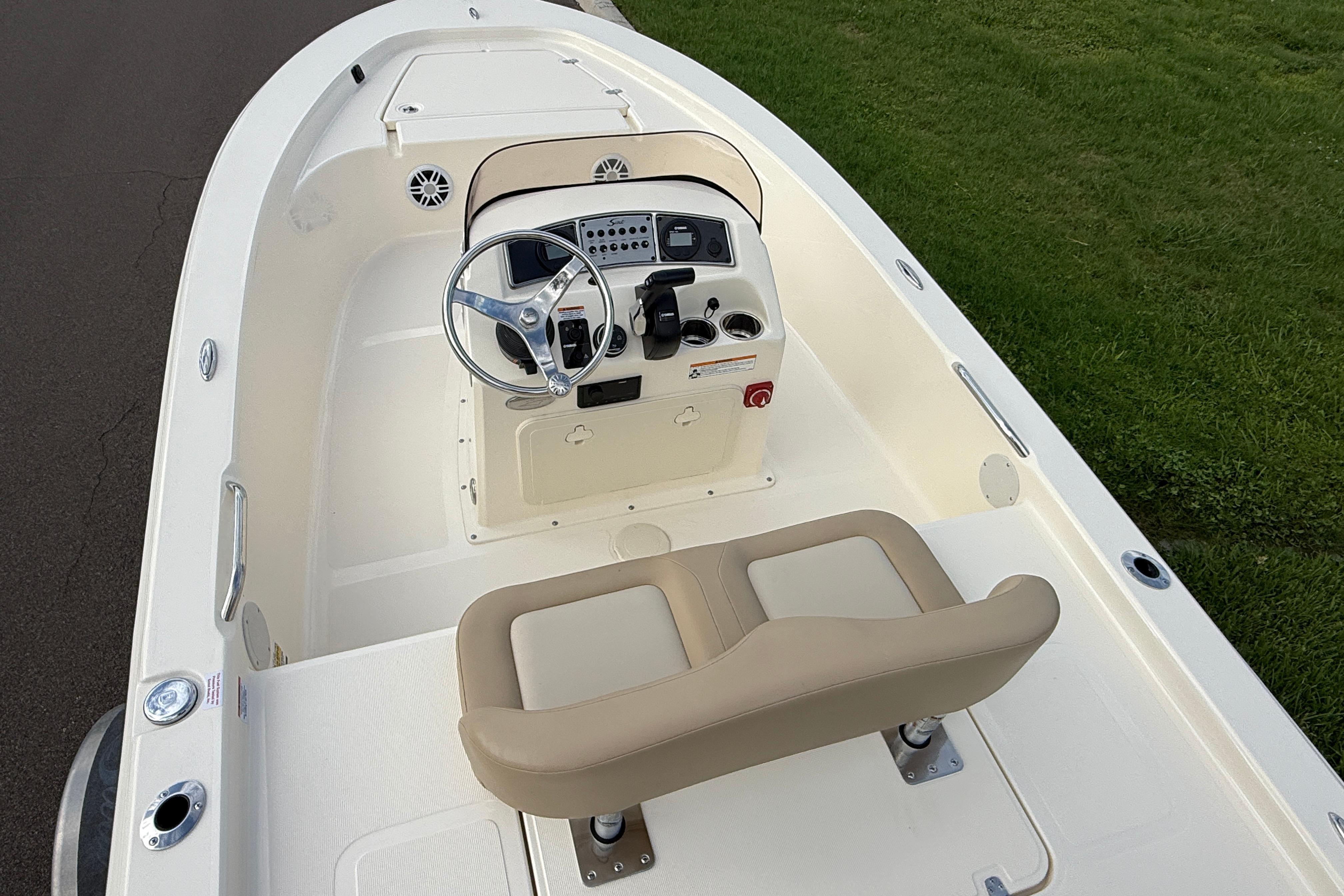 2026 Scout 177 Sport boat interior with steering console and cushioned seating.