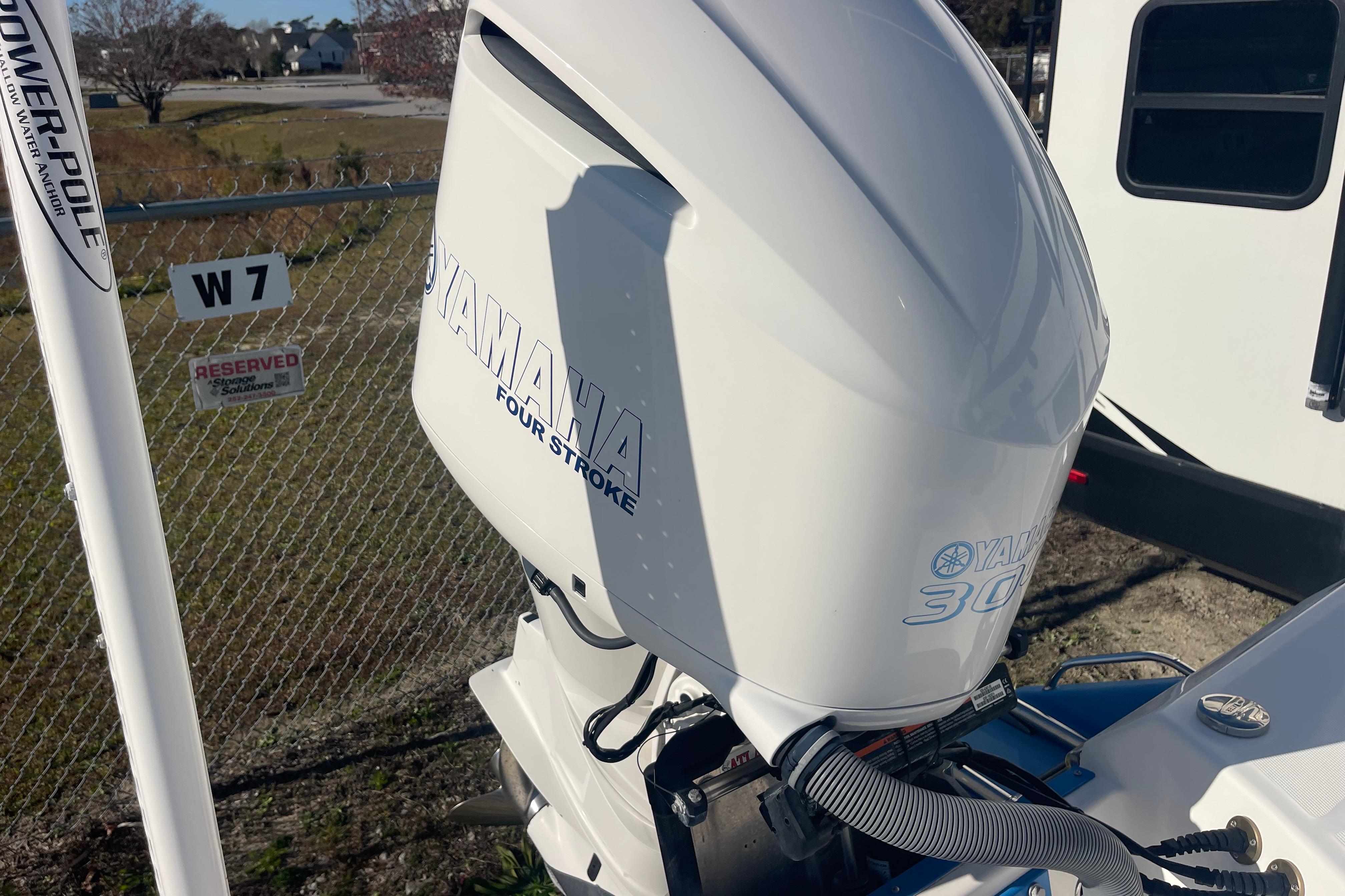 2021 Everglades 243 Center Console with Yamaha 300 four-stroke engine, parked in reserved spot.