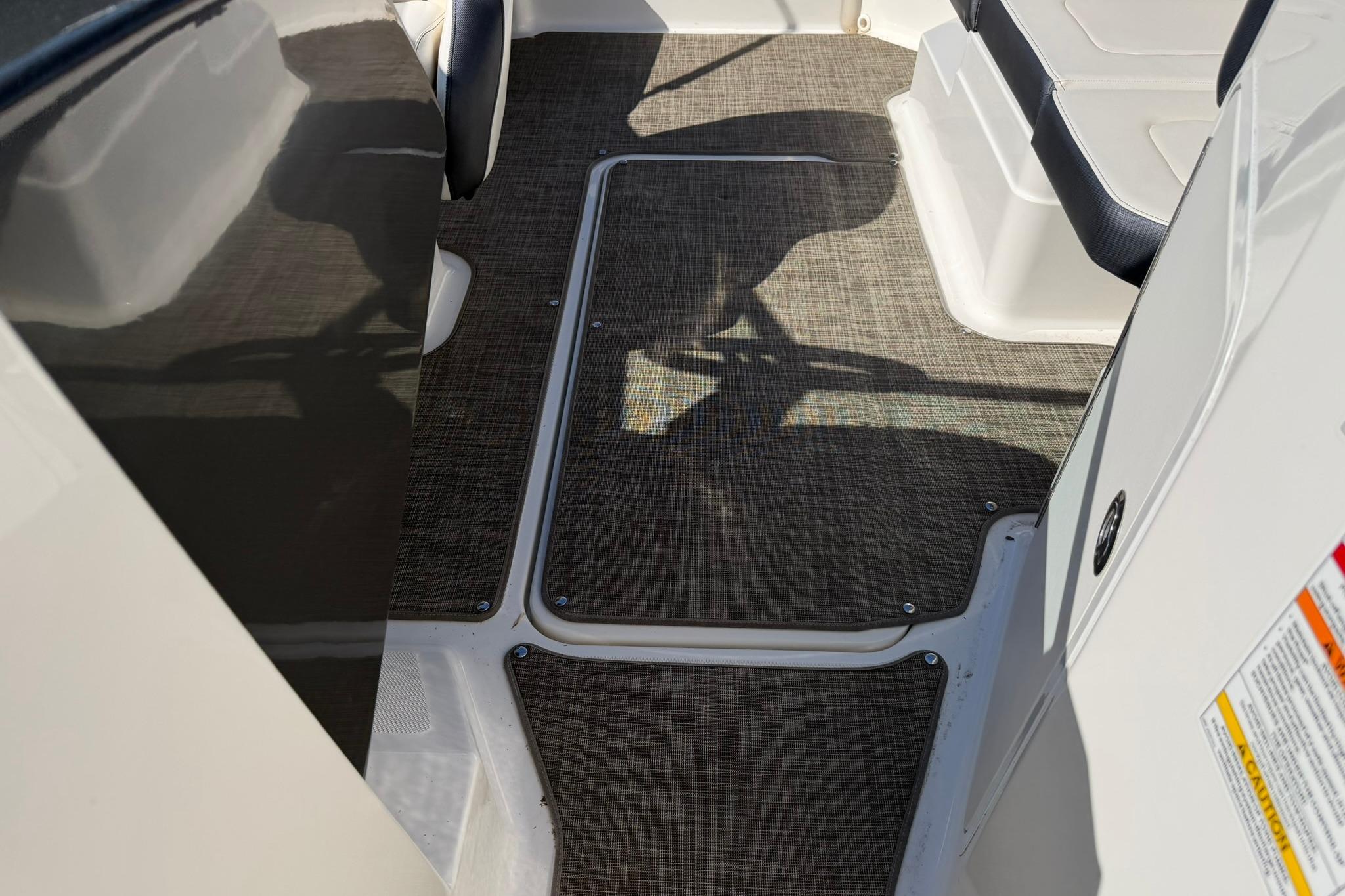 2016 Sea Ray SPX 210 boat interior with textured flooring and seating.