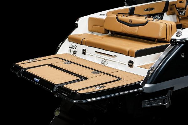 2024 Chaparral 28 Surf boat with luxurious tan seating and sleek design.
