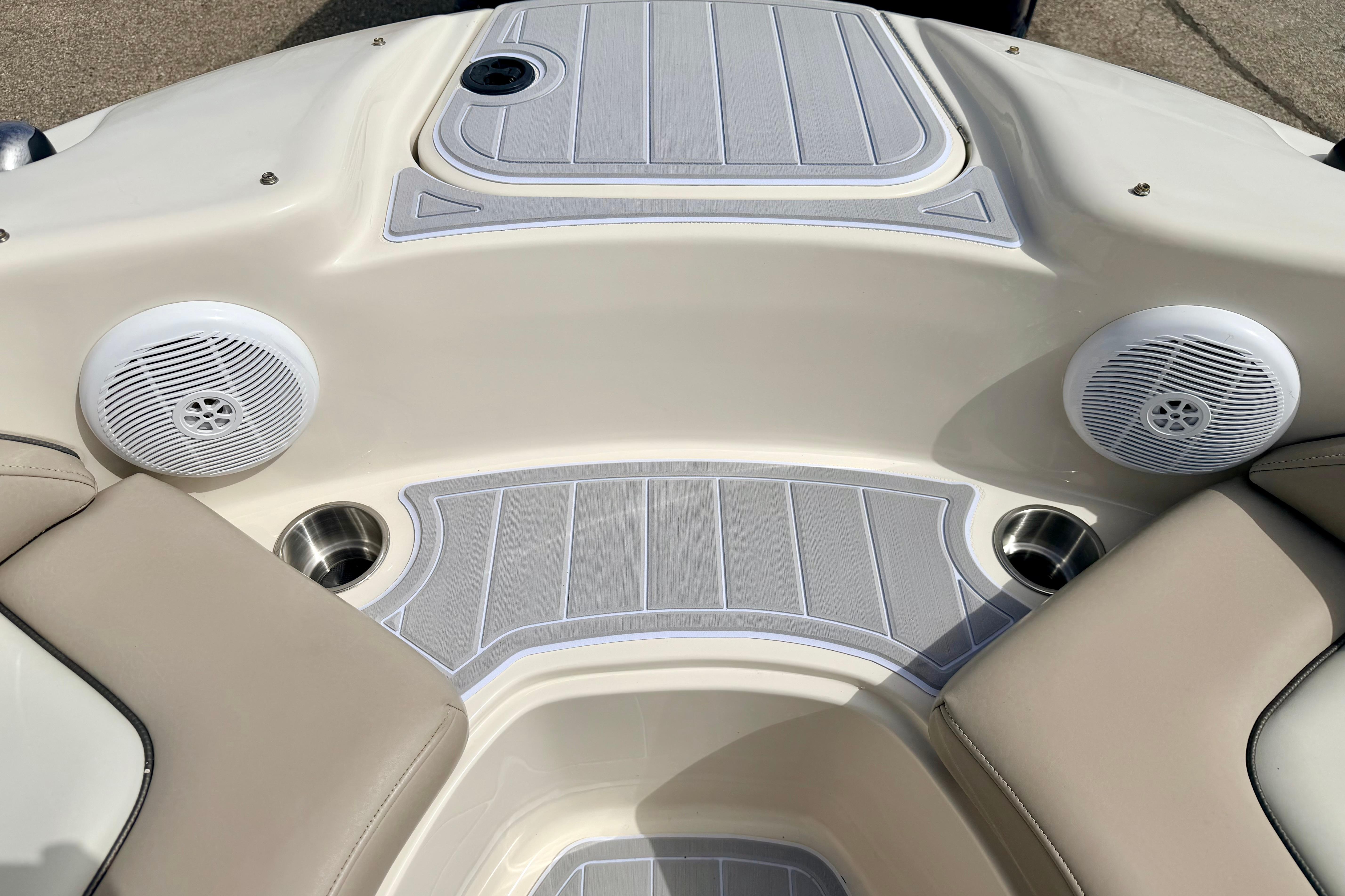 Interior of 2003 Sea Ray 200 Sundeck boat with speakers and cup holders.