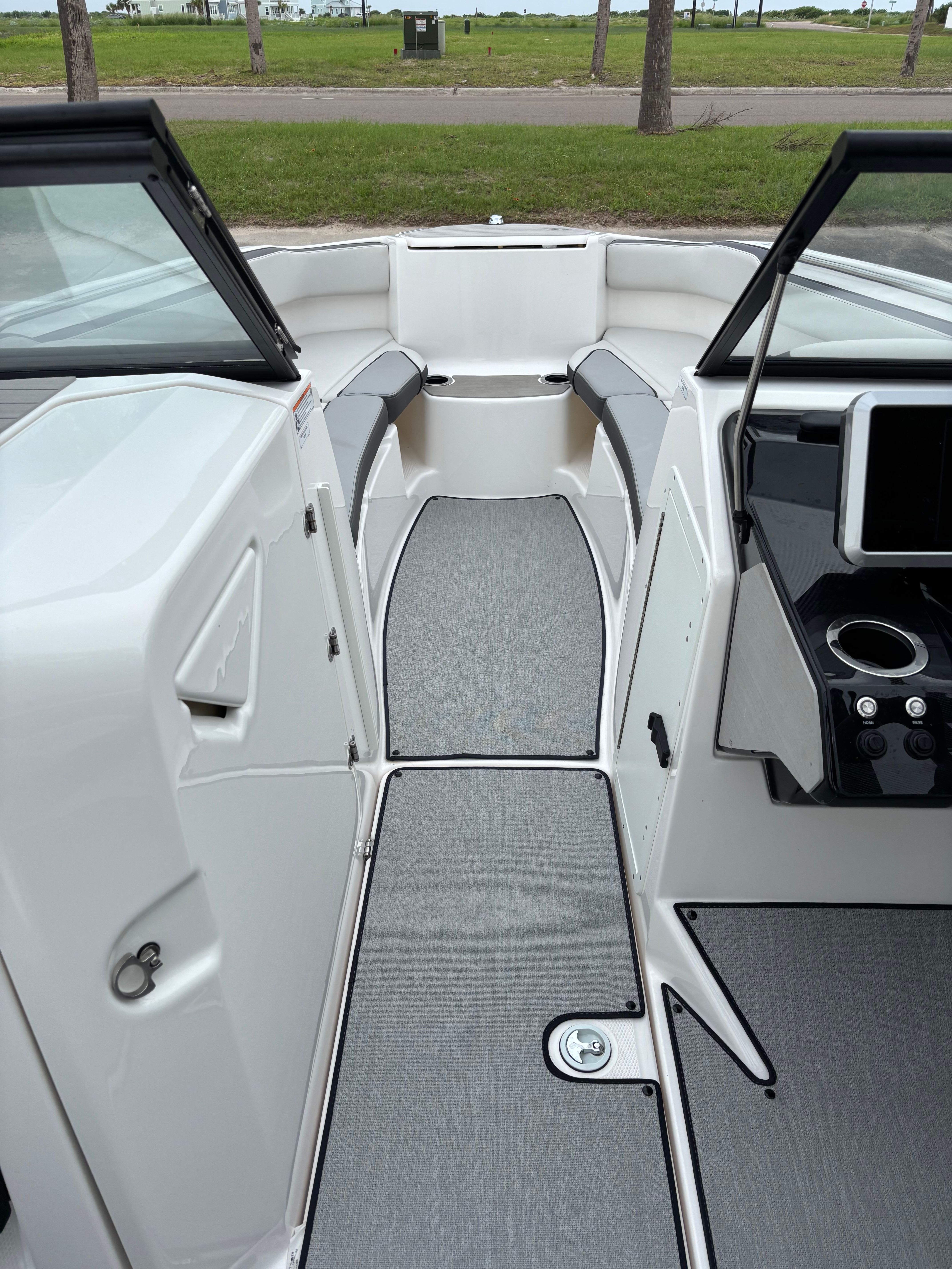 Interior view of a modern boat with gray flooring and black accents.