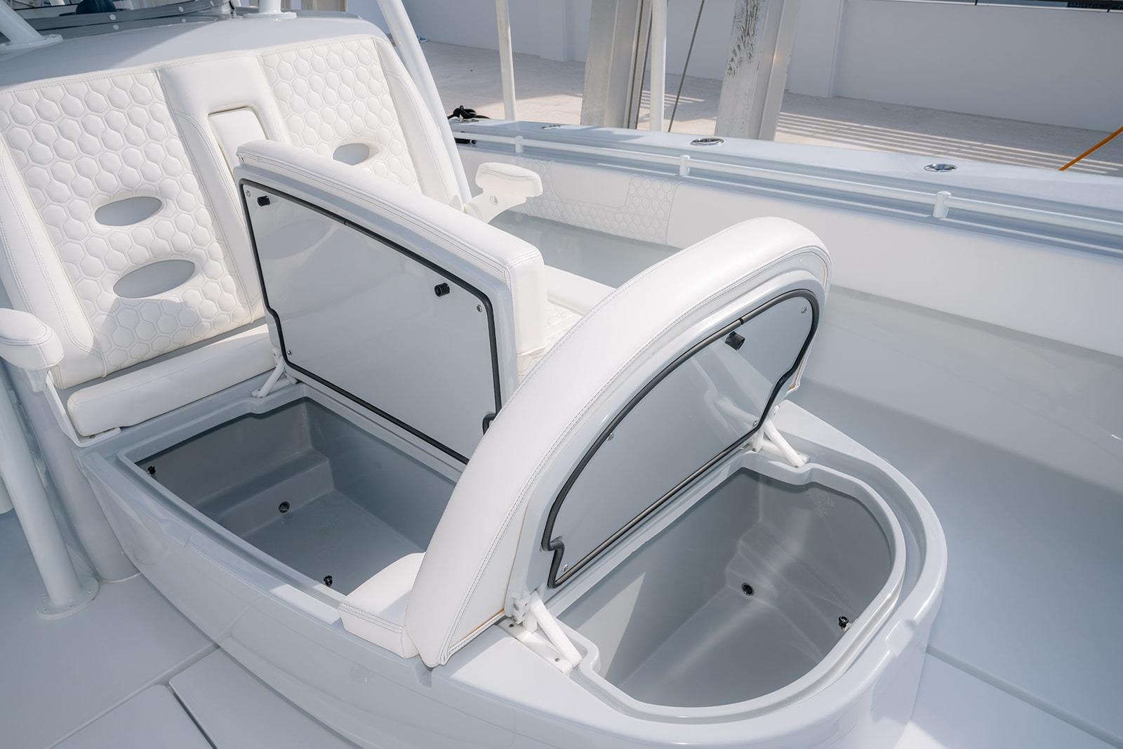 2024 Contender 44 ST boat with open storage compartments and white cushioned seating.