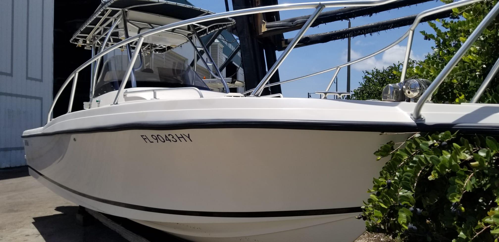 1993 Intrepid 26 Walkaround boat docked, featuring sleek design and sturdy railings.