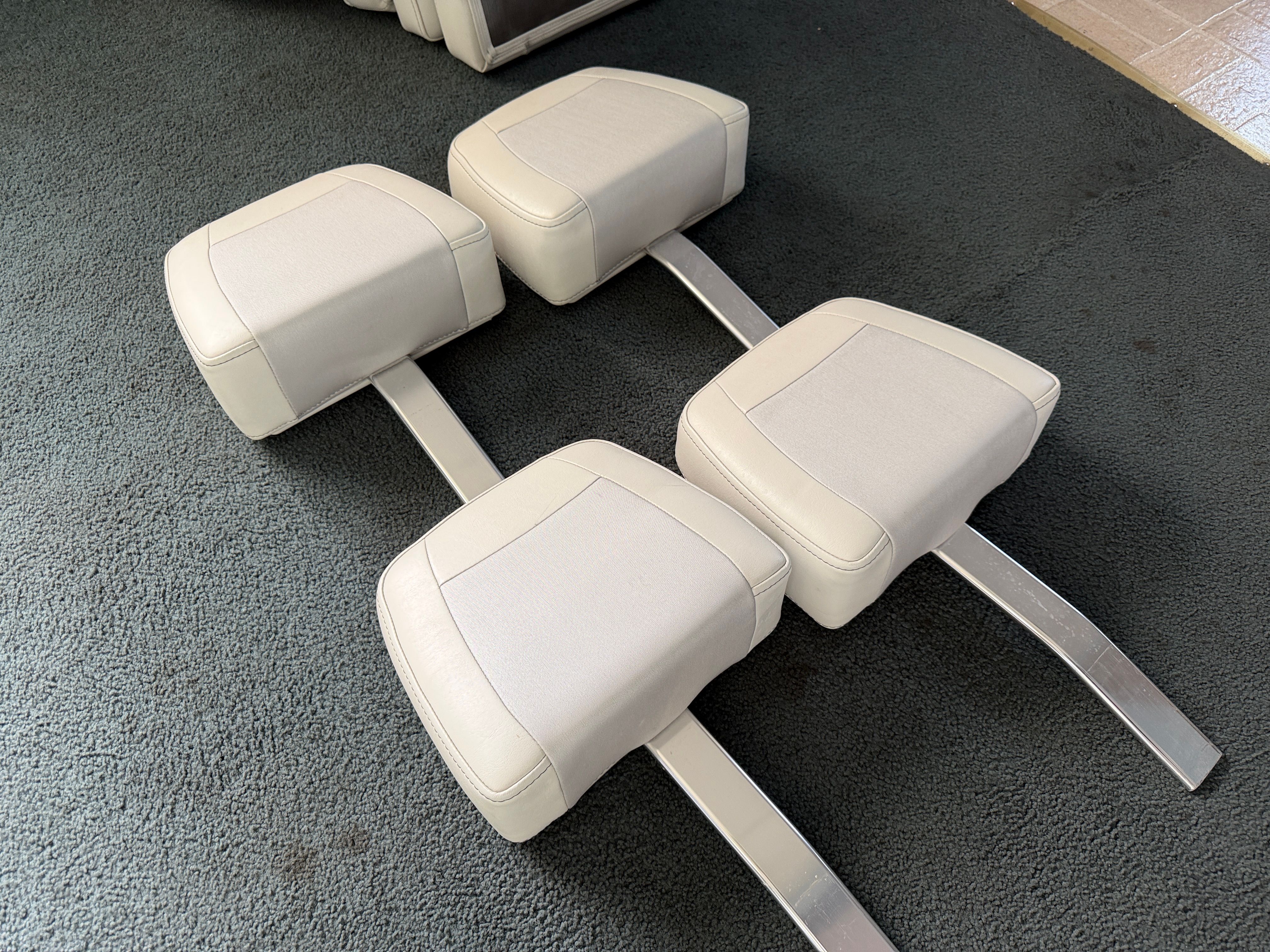 Four white boat seats on carpet, KenCraft Challenger 2021.