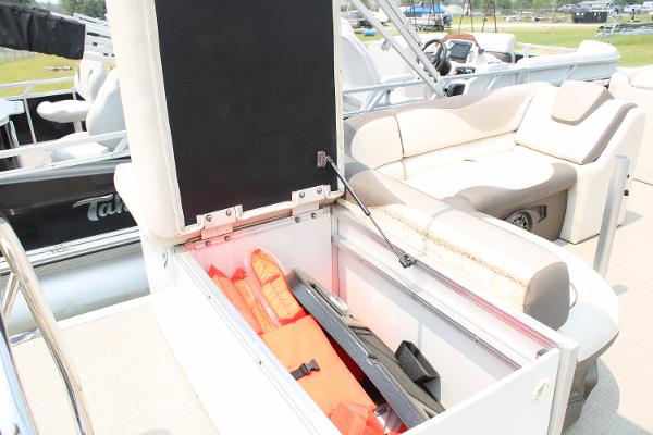 2021 Tahoe LTZ Cruise boat with open storage compartment and life jackets.