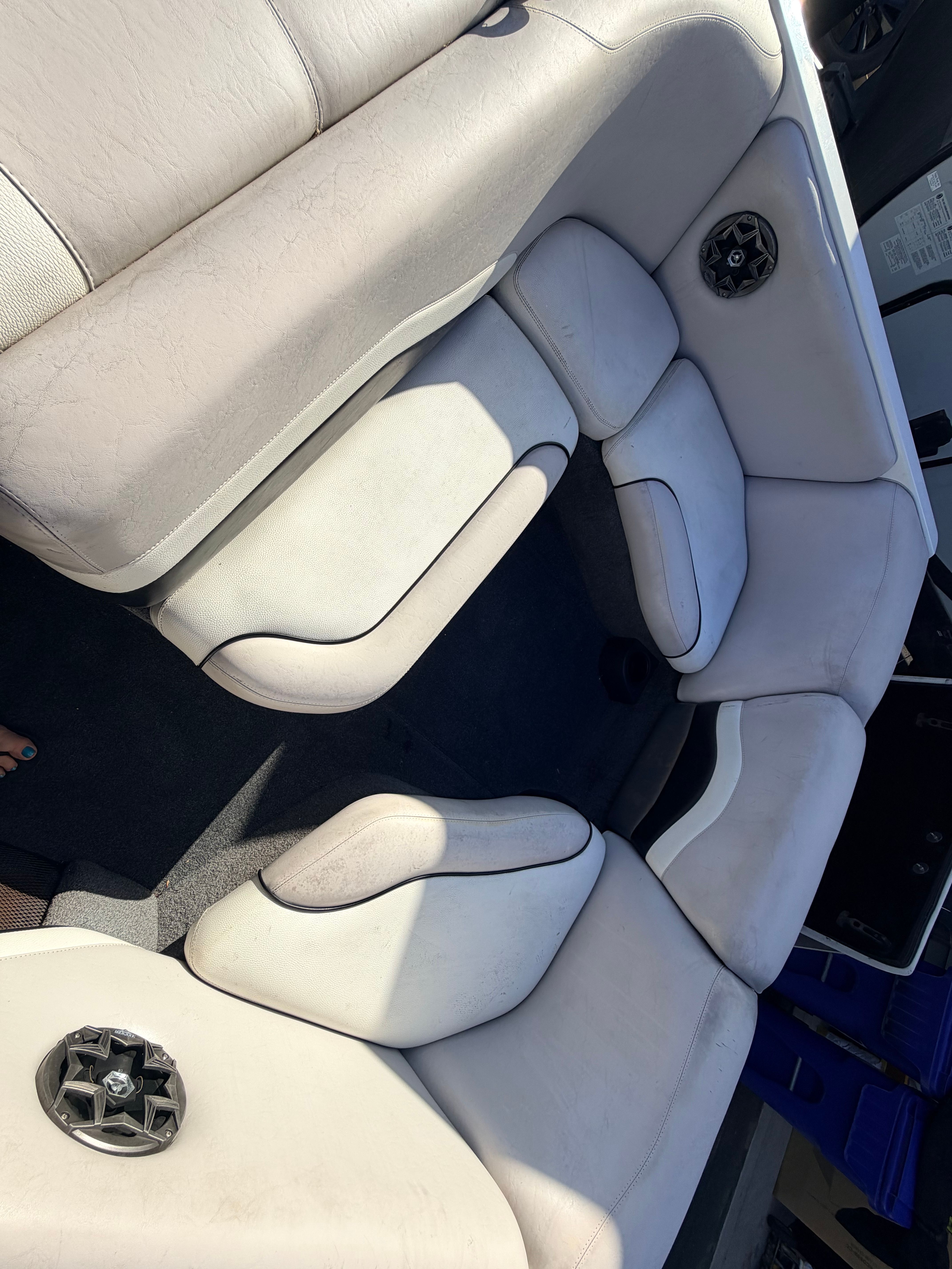 Interior of a 2006 Malibu iRide boat with white seating.
