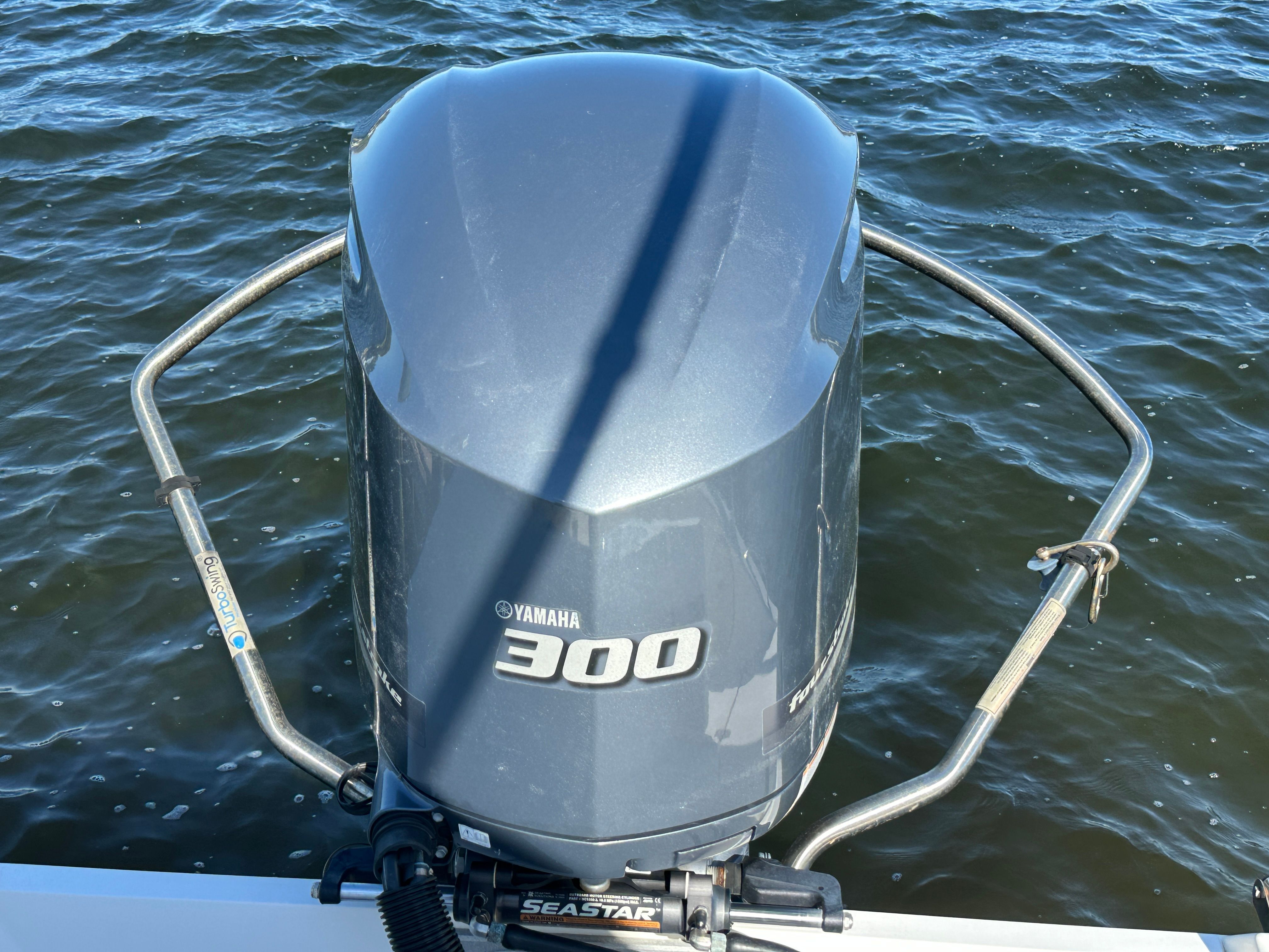 A Yamaha 300 outboard motor on a boat in the water.