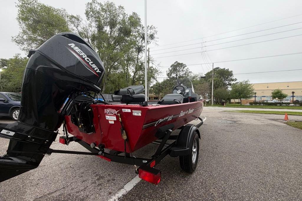 2026 Tracker Bass Tracker Classic XL boat with Mercury engine in parking lot.