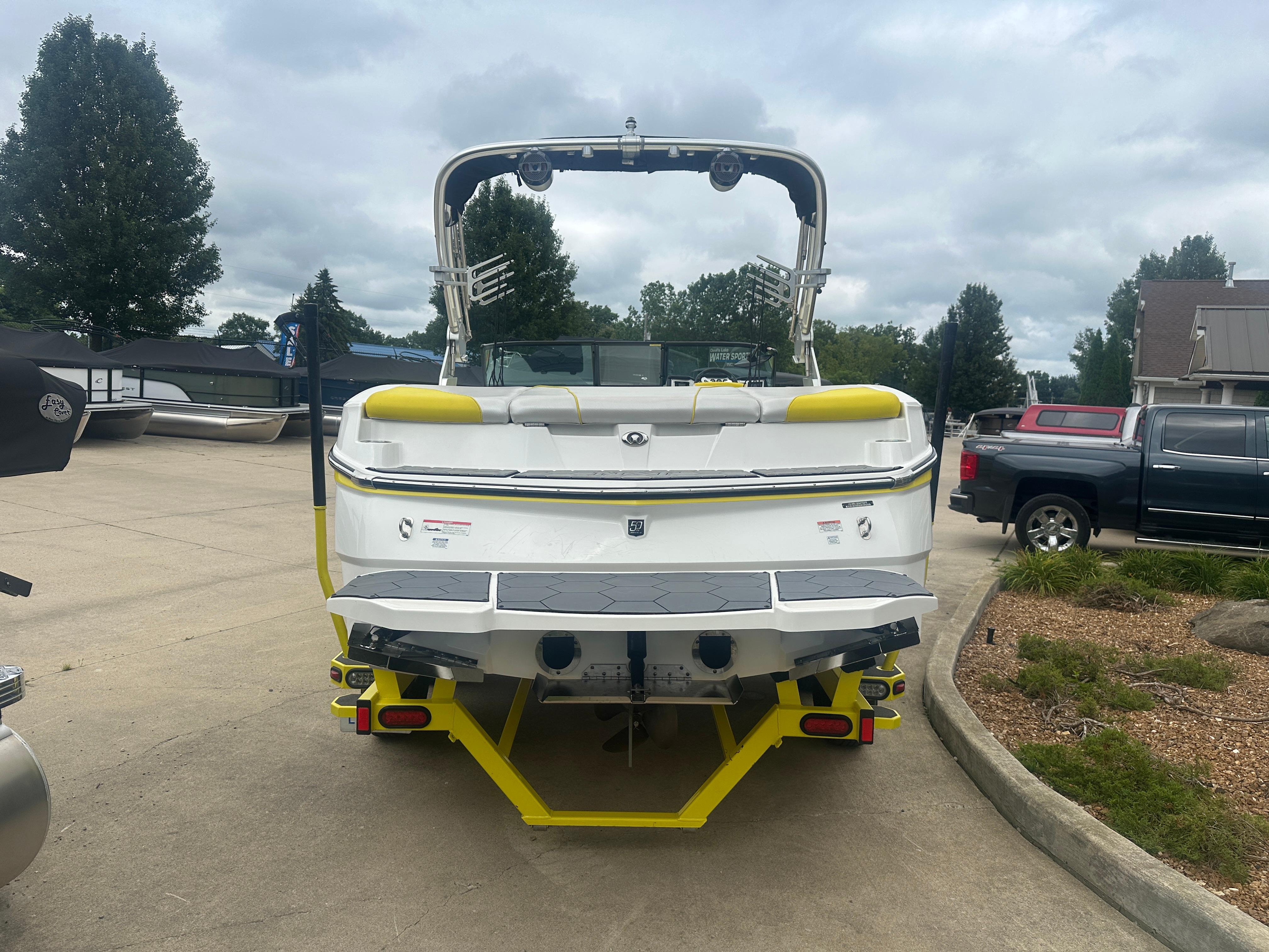 2018 MasterCraft NXT22 boat, rear view, parked outdoors on a cloudy day.