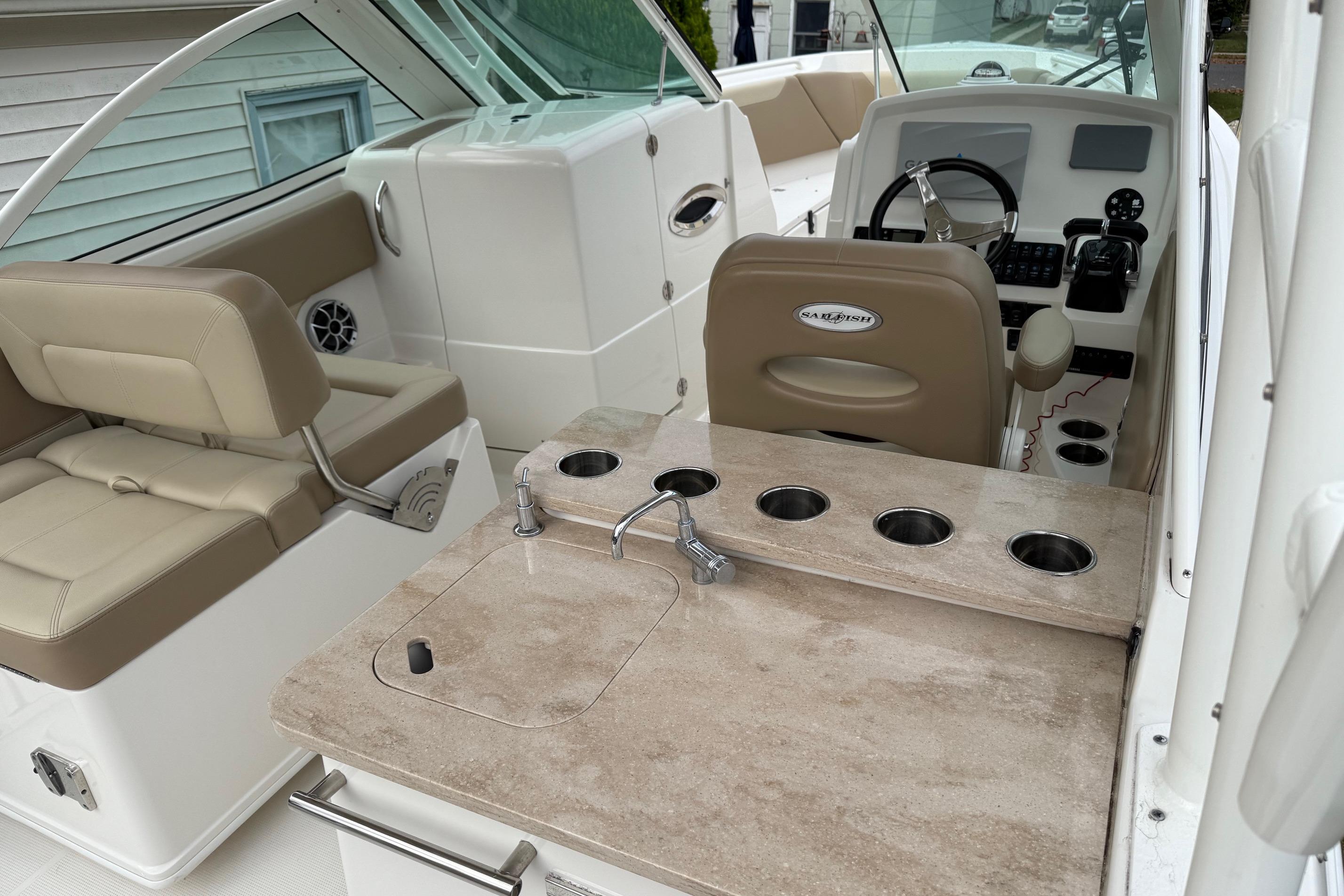 2019 Sailfish 275 DC boat interior with helm, seating, and cup holders.