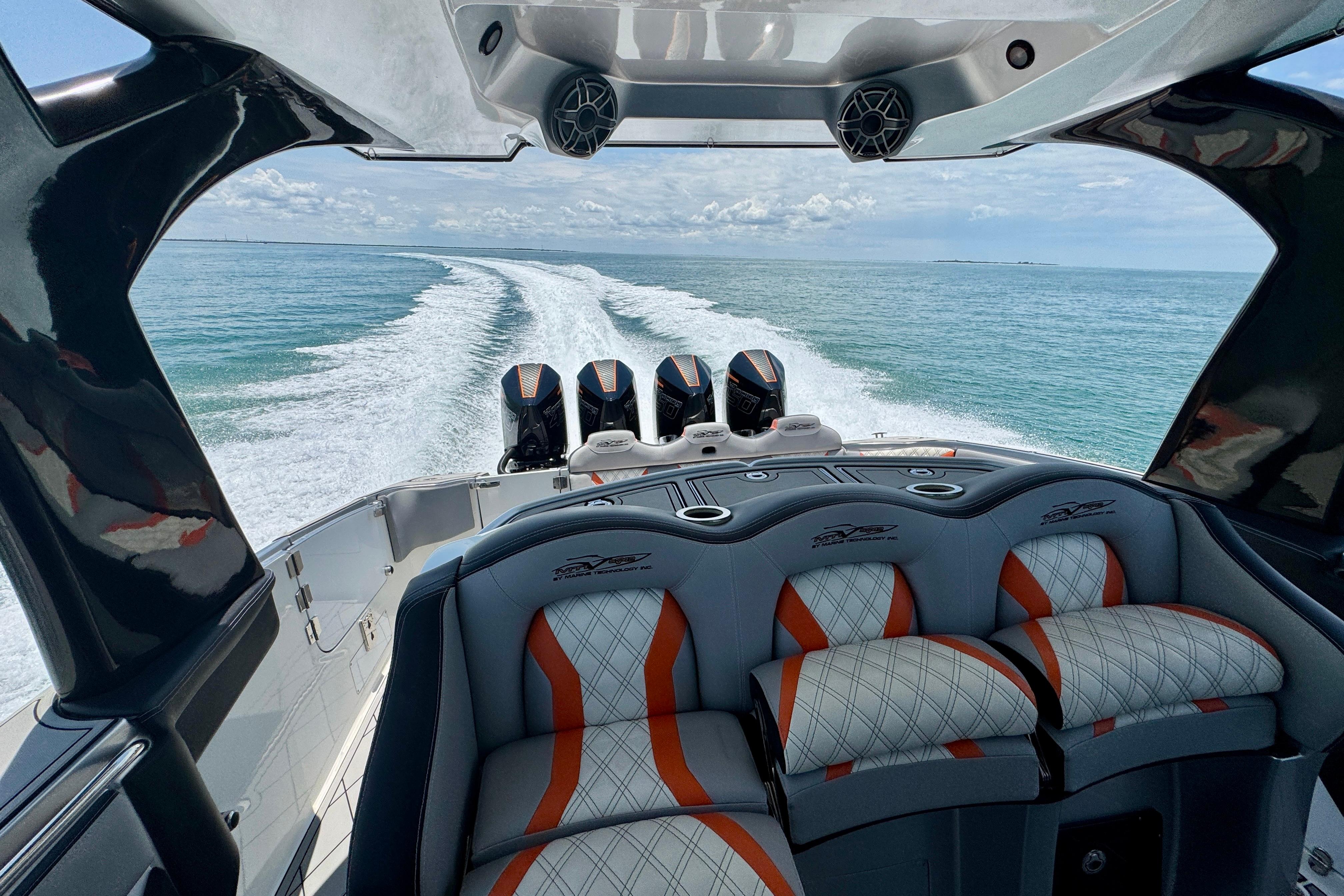 Luxury MTI V42 boat interior with quad engines cruising on open water, 2017 model.