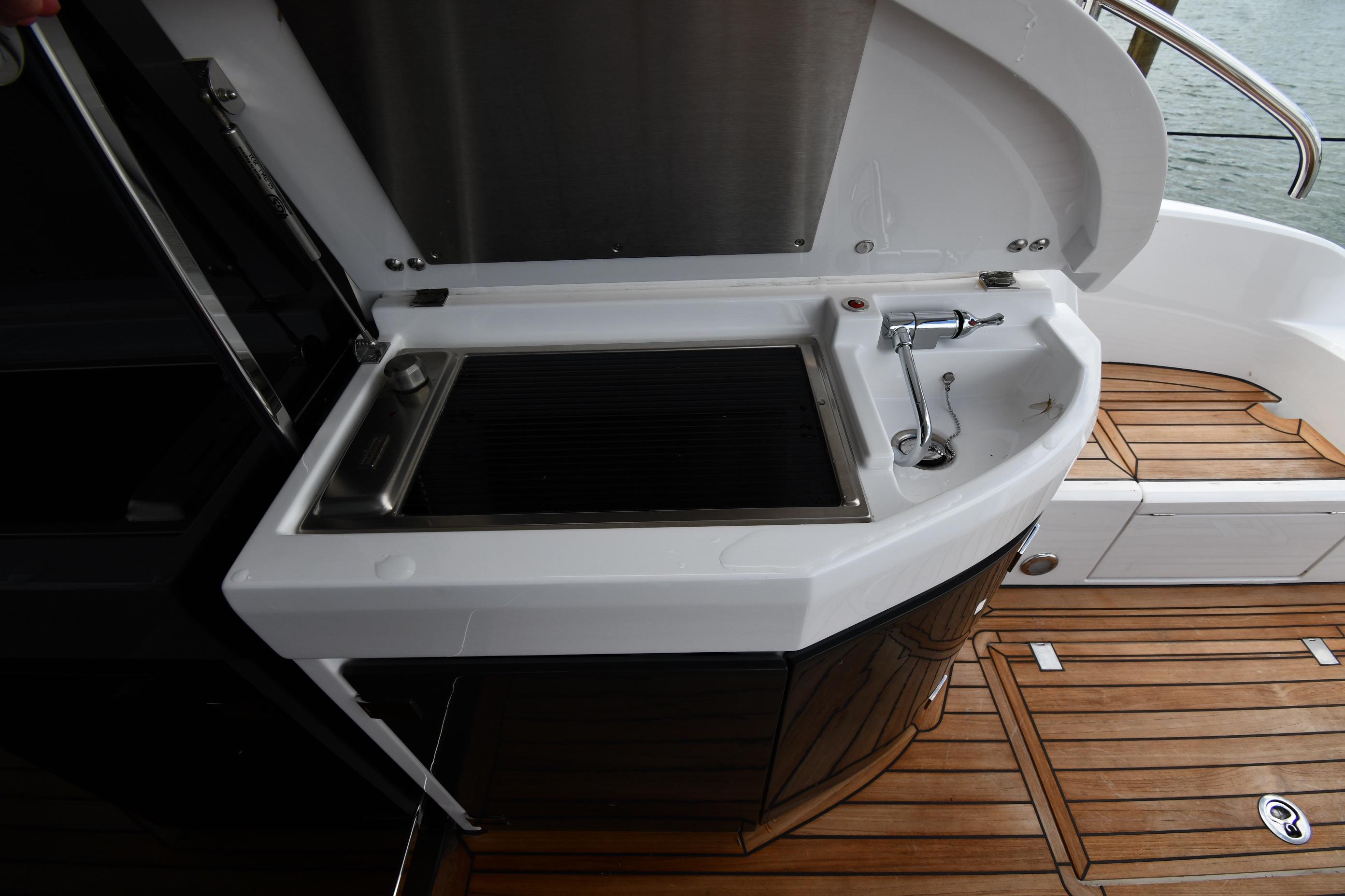 Outdoor kitchen area on 2024 Fairline G50 Targa yacht with grill and sink.