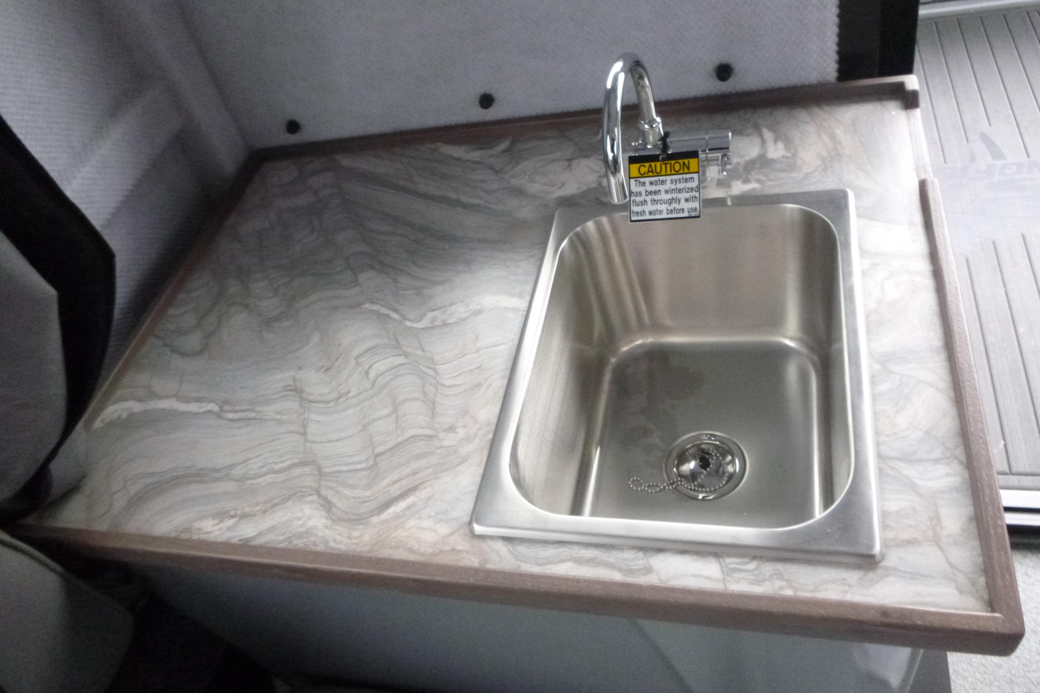 Stainless steel sink on marble countertop in 2026 KingFisher 25 XAC model.