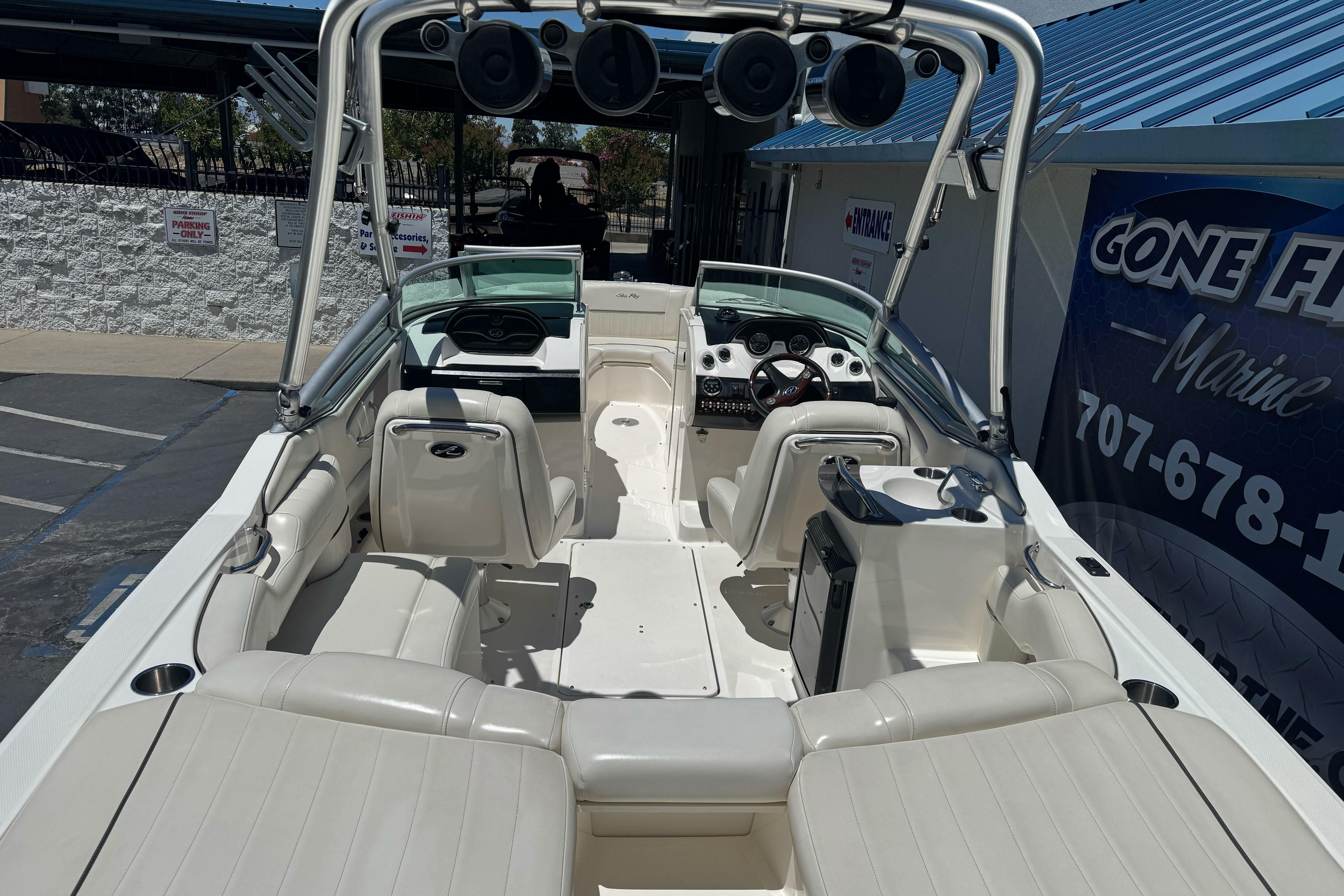 2007 Sea Ray SLX 250 boat interior with white seating and modern dashboard.