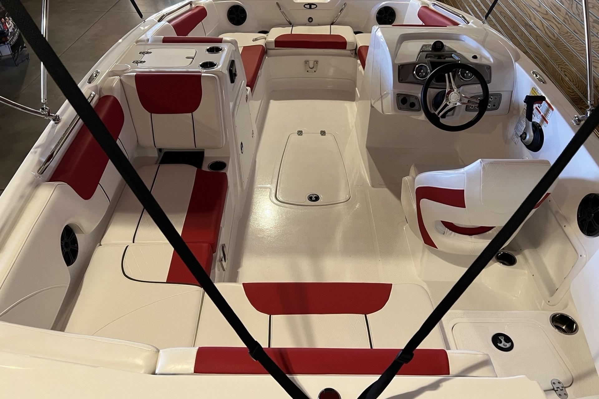 2025 Tahoe 1950 boat interior with red and white seating, steering wheel, and cup holders.