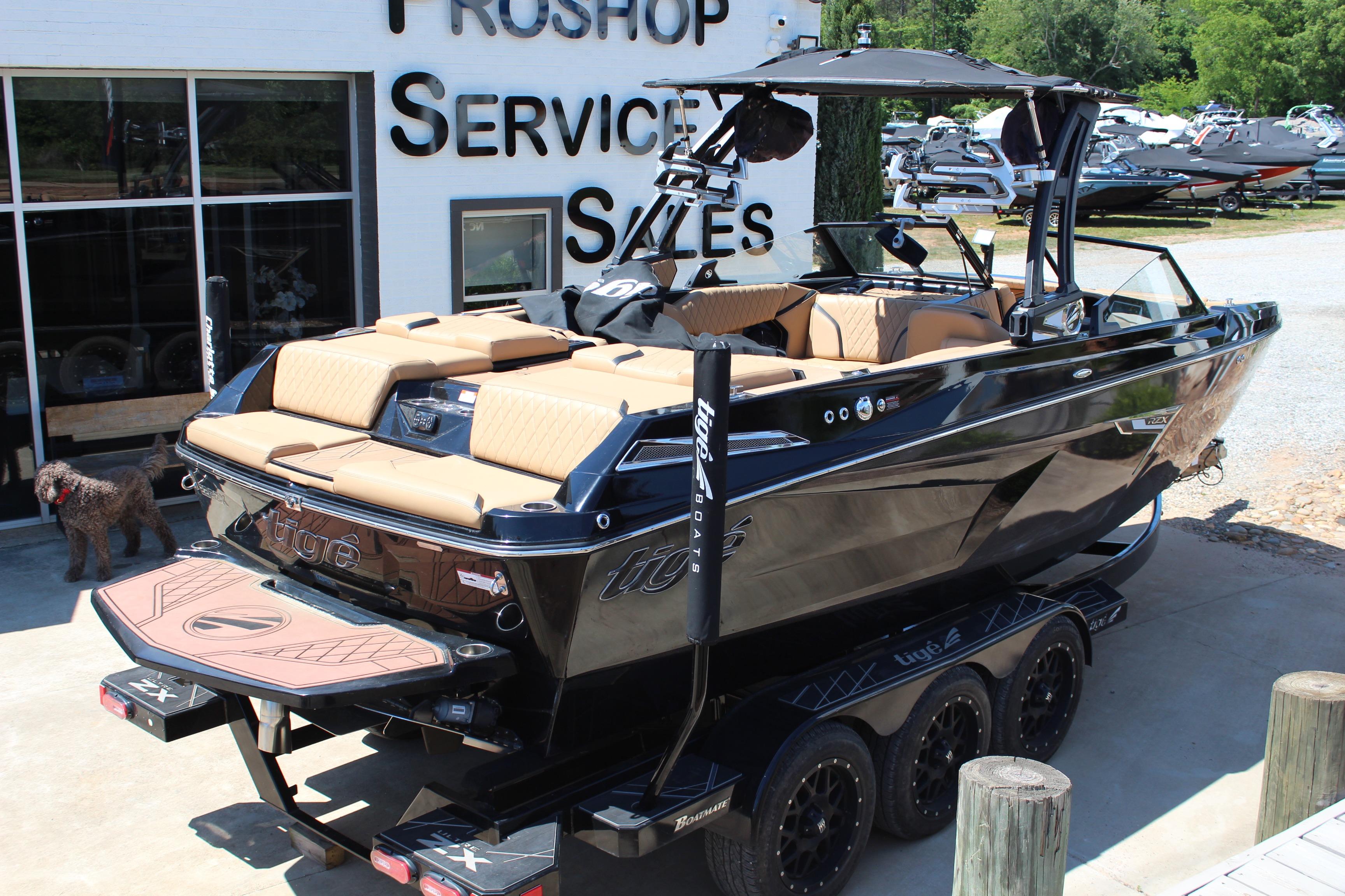 2022 Tigé 22RZX boat at dealership, showcasing sleek design and luxurious interior.