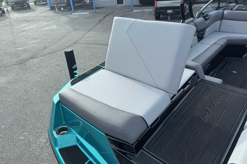 2026 Moomba Tykon boat interior with gray seating and teal accents.
